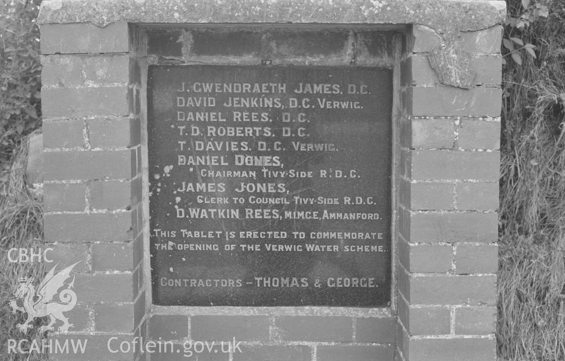 Digital copy of a black and white negative showing inscription on granite plaque, by the road immediately west of the church. Photographed by Arthur Chater on 30 August 1968. Looking south west from Grid Reference SN 184 495.