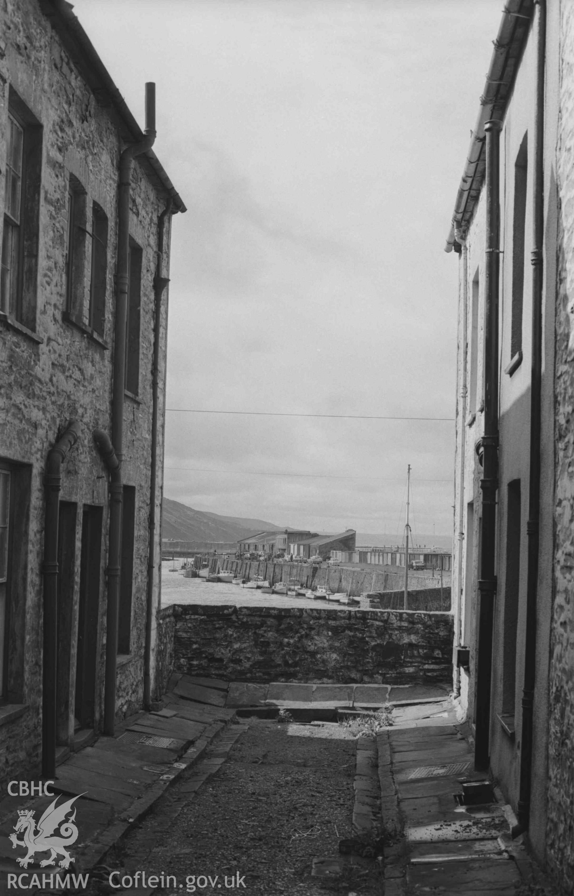 Digital copy of a black and white negative showing view looking through Rheidol Place to the harbour, Aberystwyth. Photographed by Arthur Chater on 2 September 1968. Looking south south west from Grid Reference SN 5814 8140.