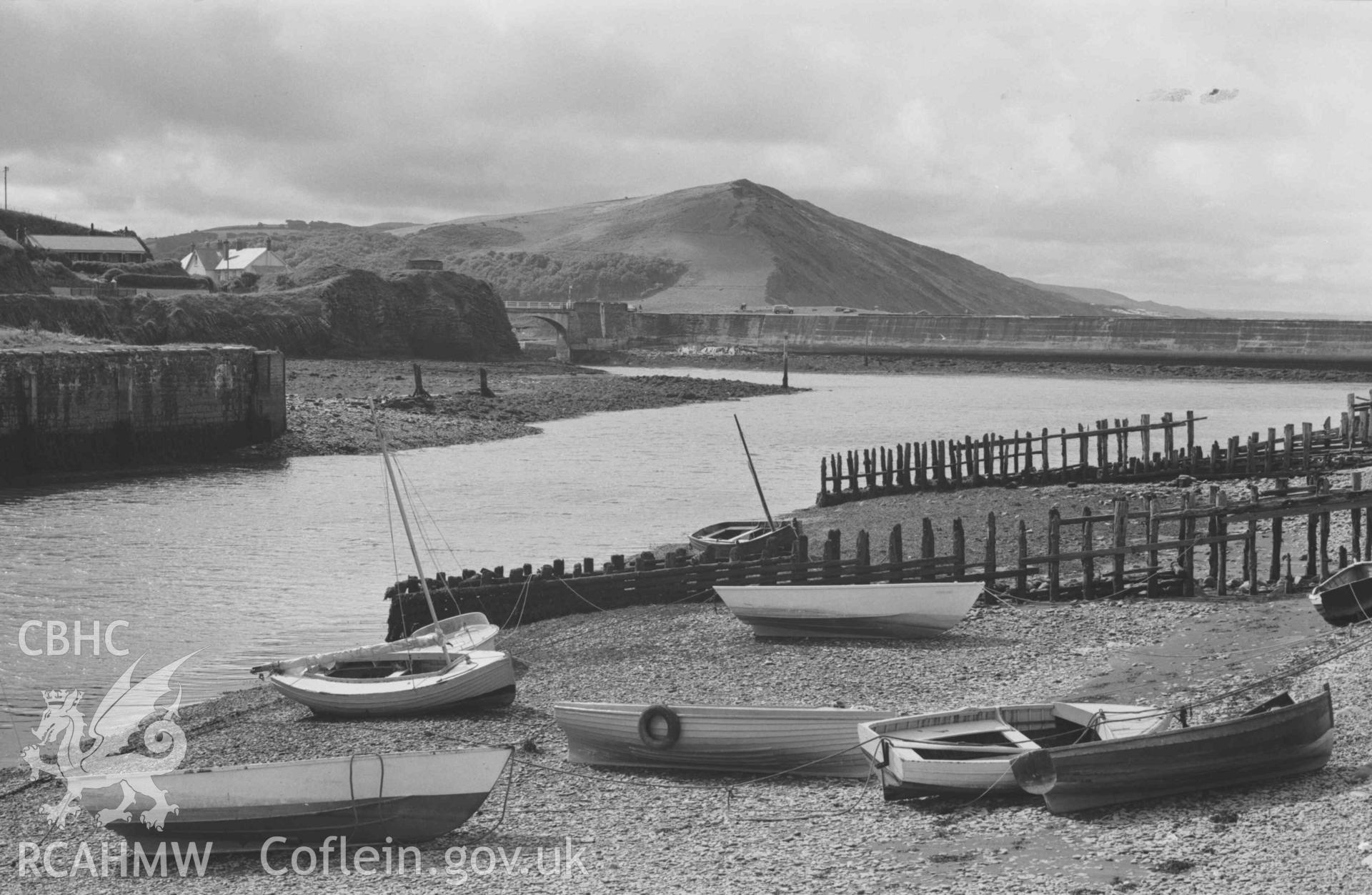 Digital copy of a black and white negative showing view of Allt-Wen across the confluence of the Ystwyth and Rheidol from the south end of the harbour quay. Photographed by Arthur Chater on 2 September 1968. Looking south from Grid Reference SN 580 810.