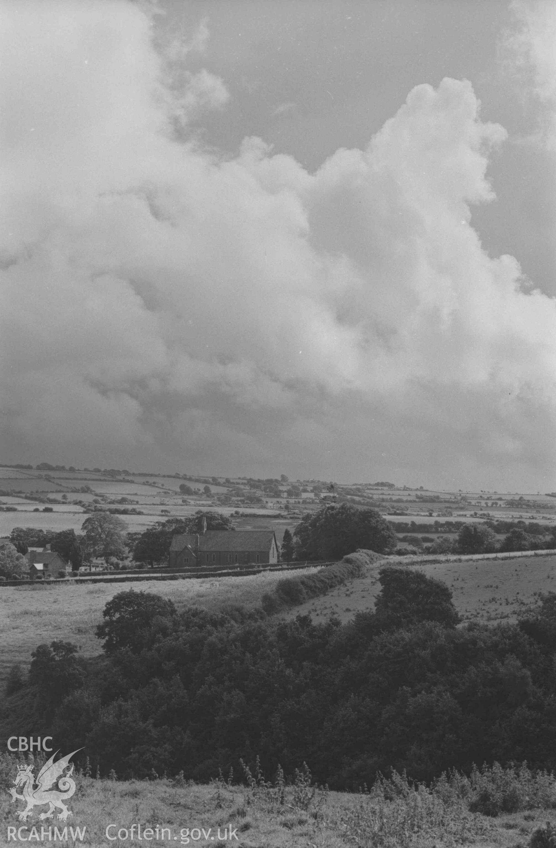 Digital copy of a black and white negative showing Llangwyrfon Church from the main road on the north side of the Wyre. Photographed by Arthur Chater on 2 September 1968. Looking south from Grid Reference SN 595 708.
