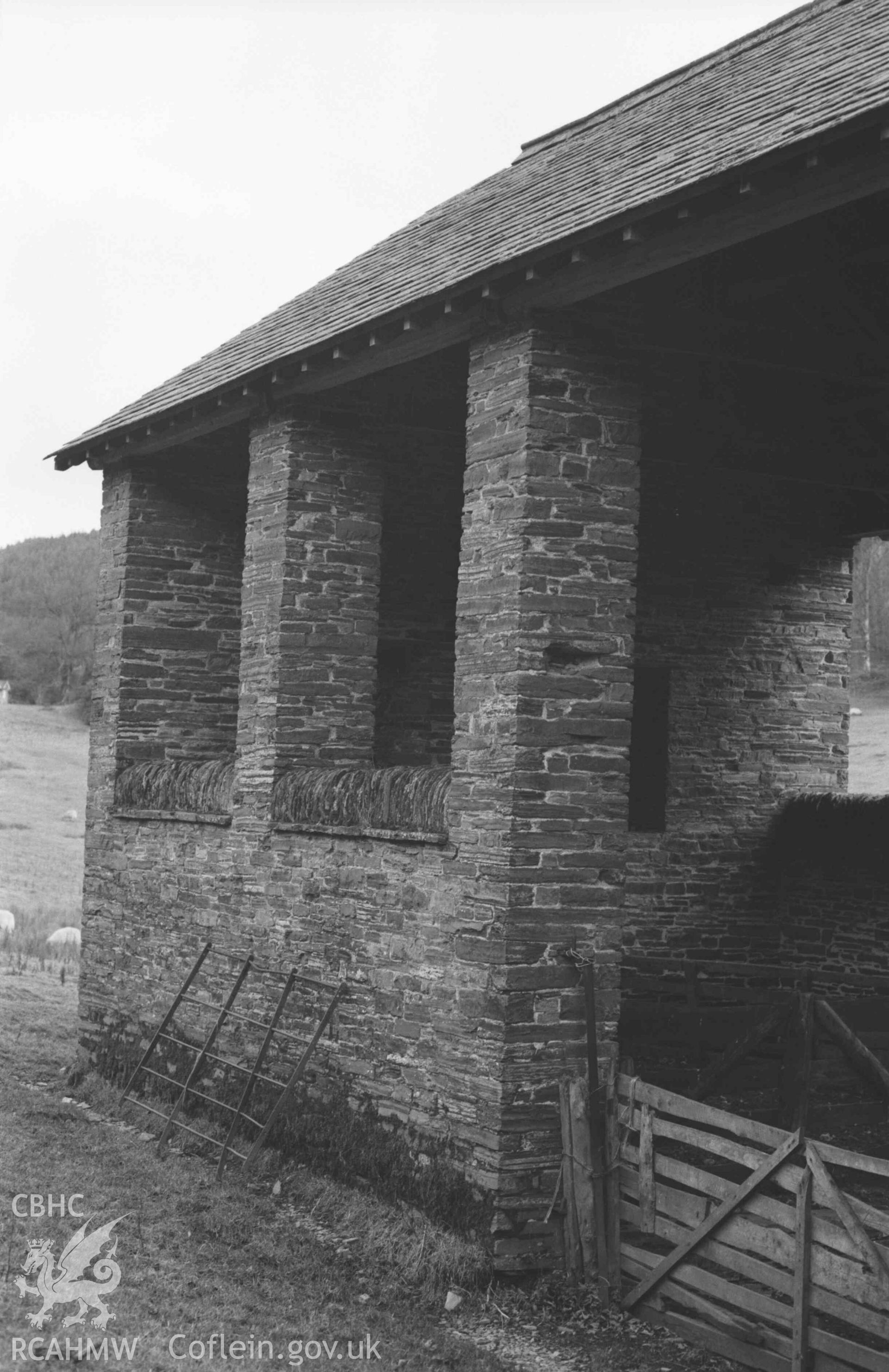 Digital copy of a black and white negative showing large barn in field immediately behind Hafod-Uchtryd. Photographed by Arthur Chater on 23 December 1968. Looking east from Grid Reference SN 7596 7332.
