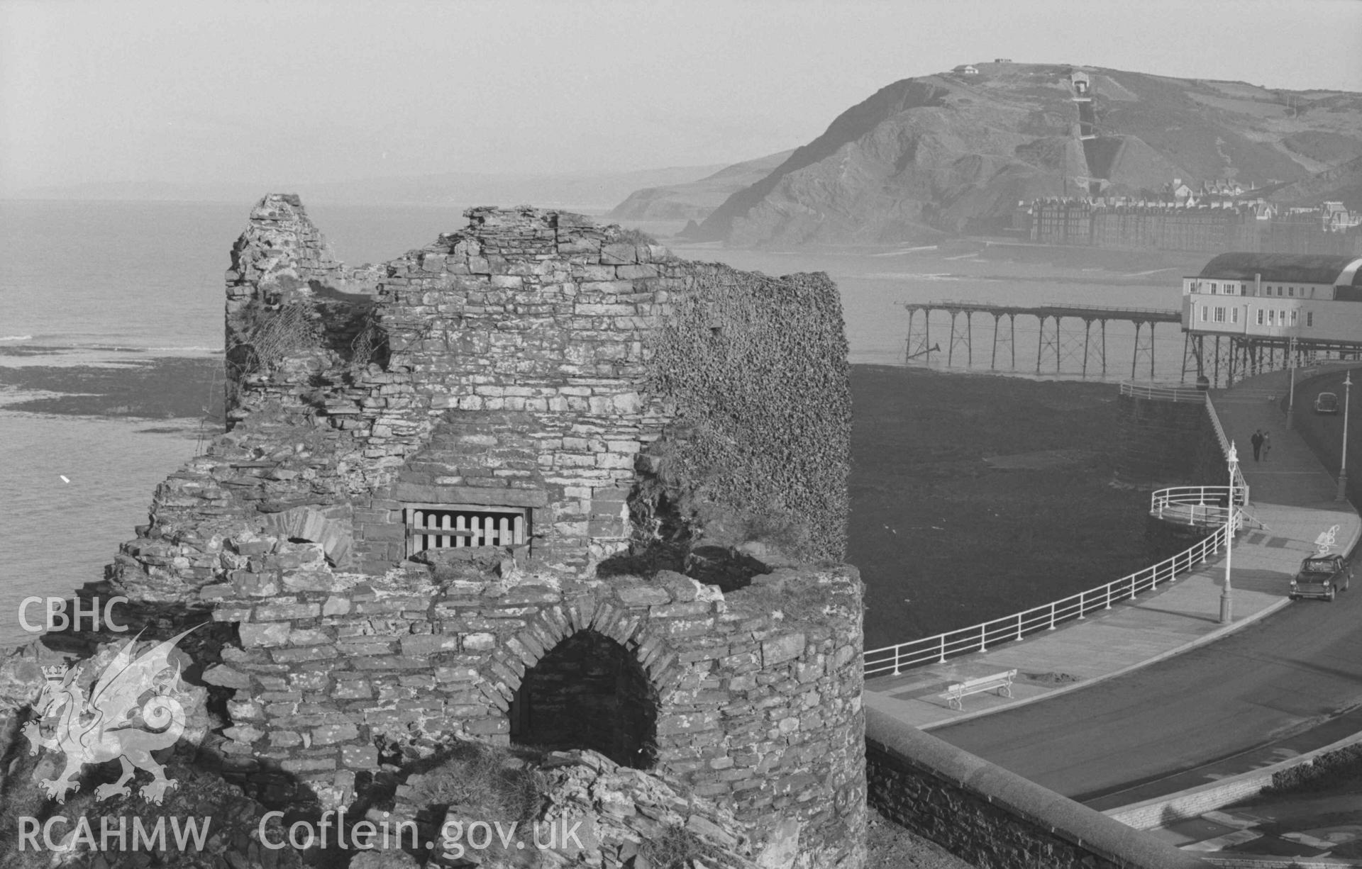 Digital copy of a black and white negative showing view of the Pier and Constitution Hill from Aberystwyth Castle. Photographed by Arthur Chater on 27 December 1968. Looking north east from Grid Reference SN 5796 8158.