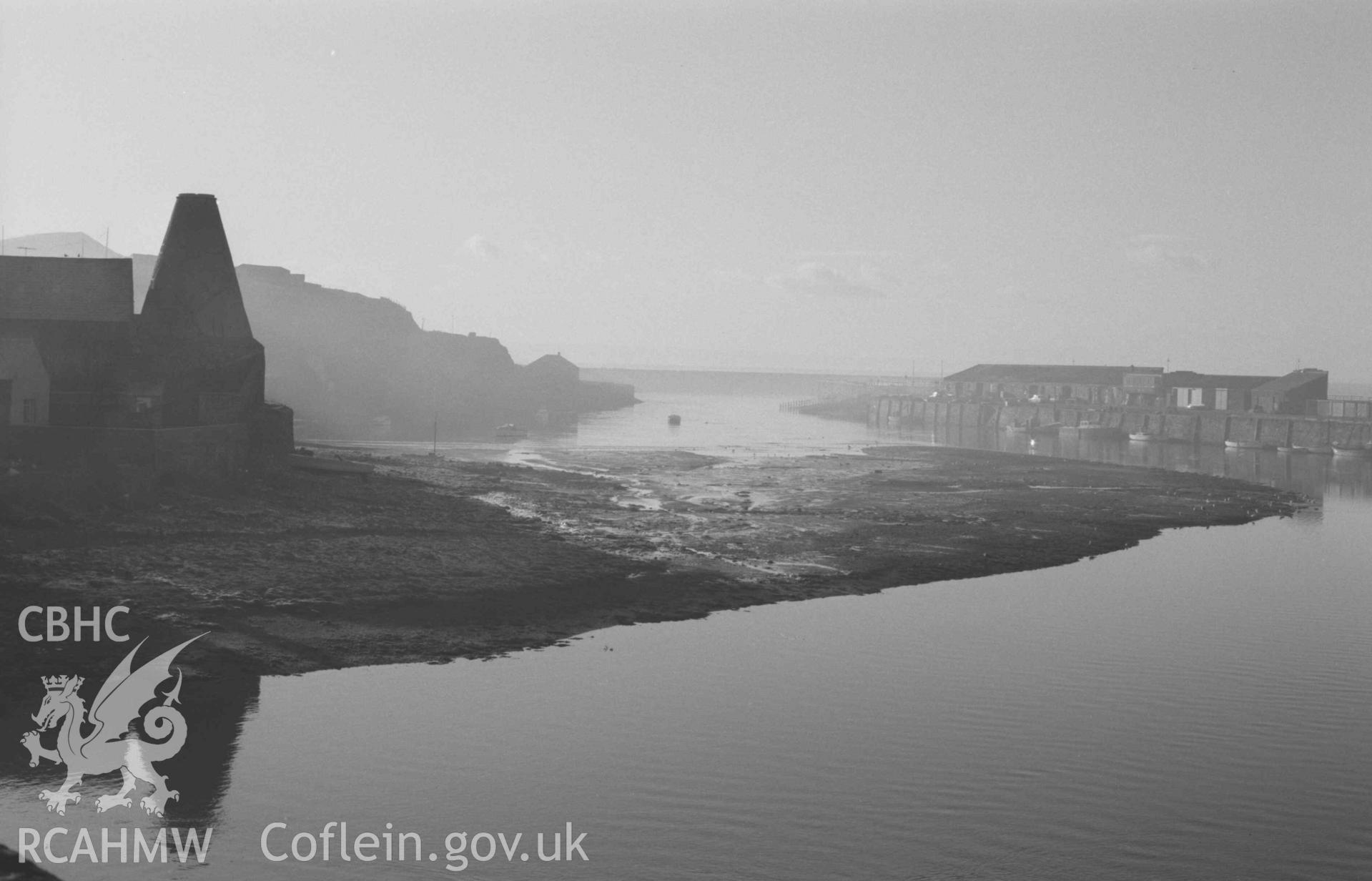 Digital copy of a black and white negative showing oast house and harbour from Trefechan Bridge. Photographed by Arthur Chater on 27 December 1968. Looking south south west from Grid Reference SN 5827 8133.