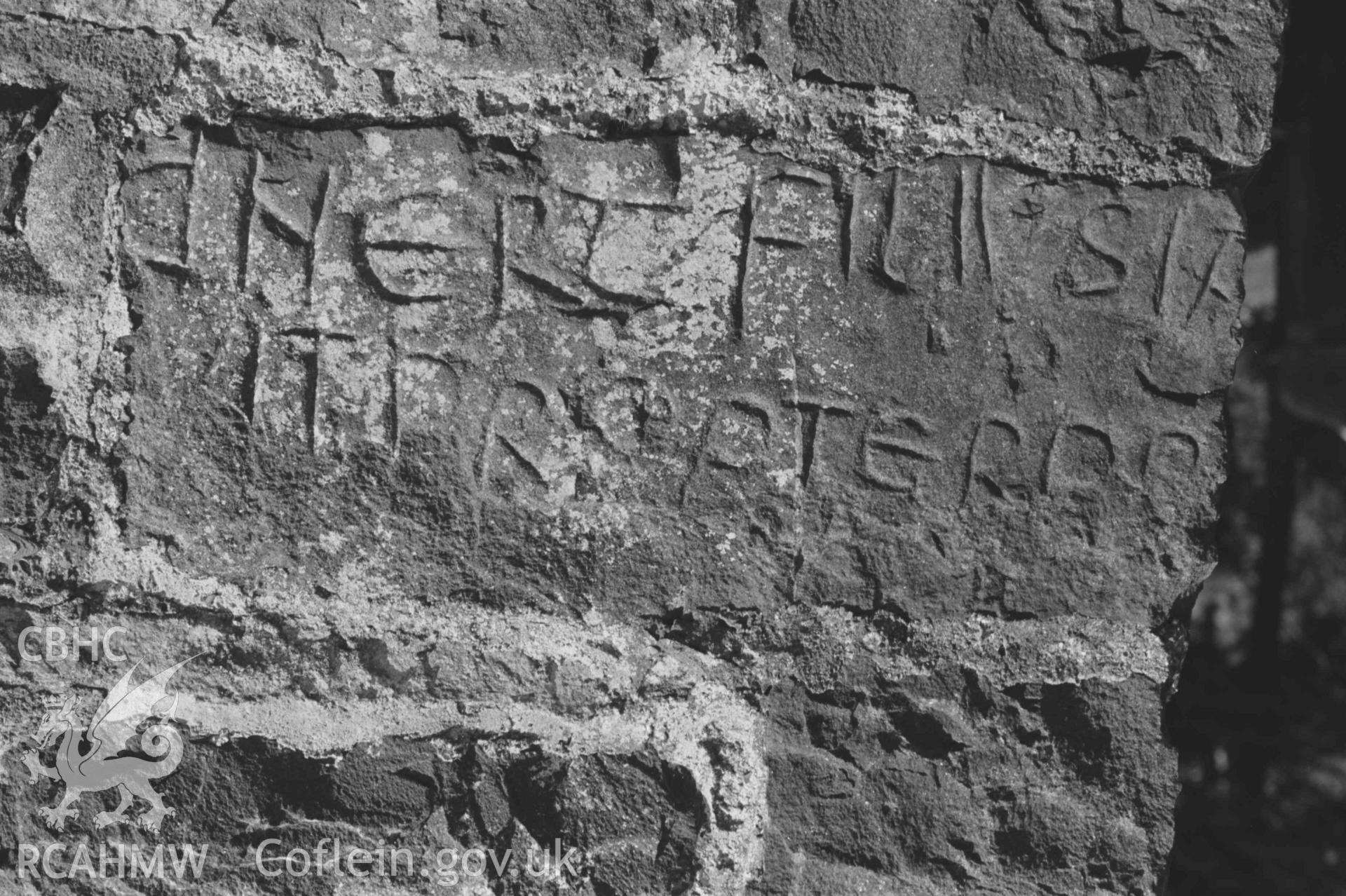 Digital copy of a black and white negative showing inscribed stones set in the west wall of the church at Llanddewi-Brefi. Photographed by Arthur Chater on 22 August 1968. Grid Reference SN 664 553.