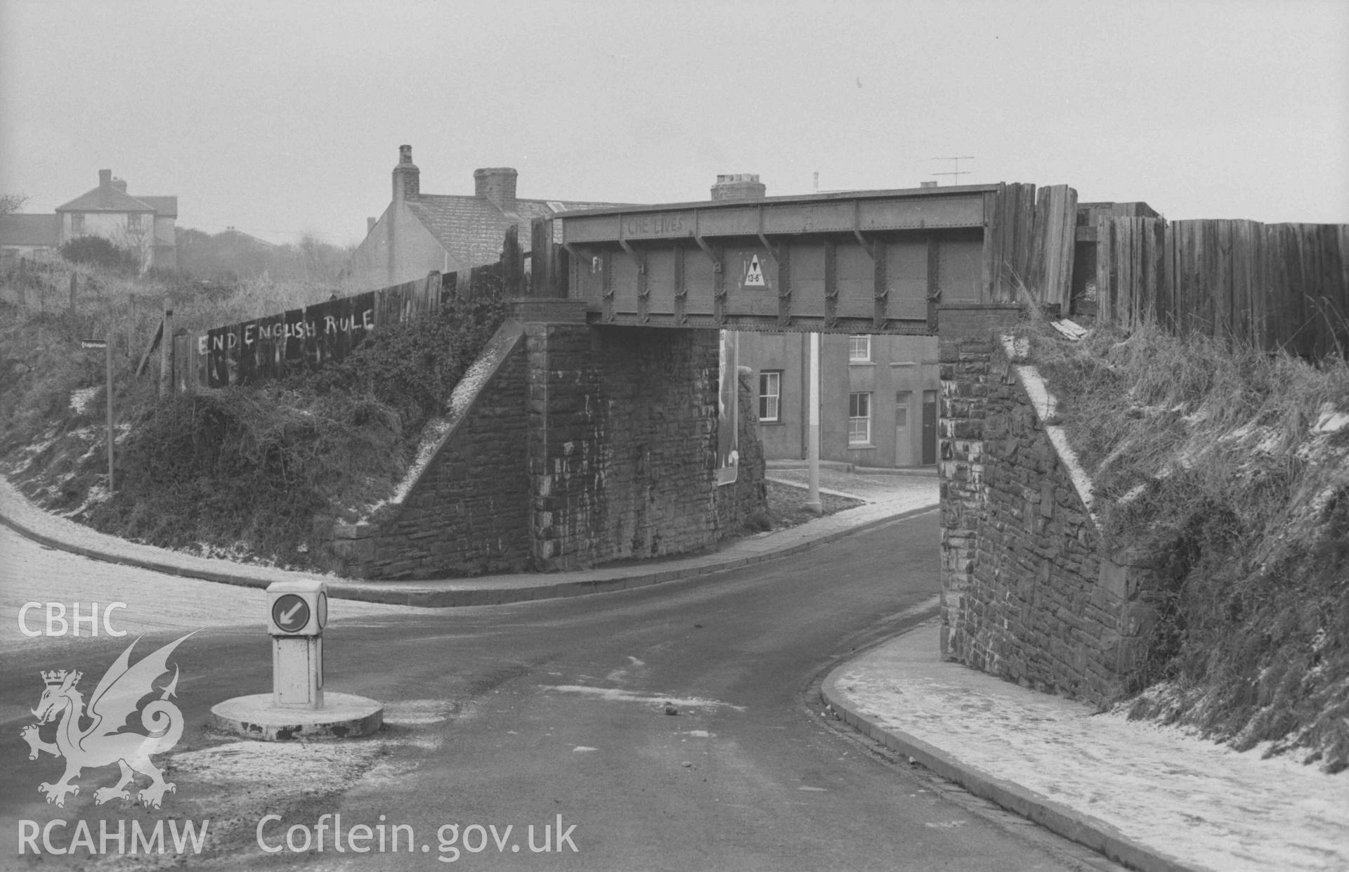 Digital copy of a black and white negative showing railway bridge at the bottom of Penparcau Road. Photographed by Arthur Chater on 28 December 1968. Looking west from Grid Reference SN 5834 8103.