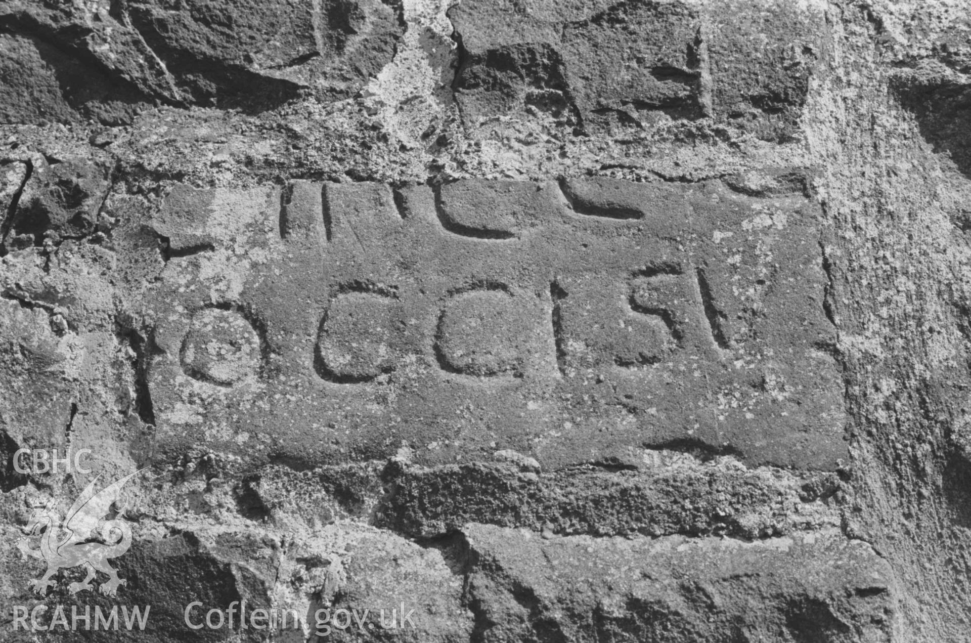 Digital copy of a black and white negative showing inscribed stones set in the west wall of the church at Llanddewi-Brefi. Photographed by Arthur Chater on 22 August 1968. Grid Reference SN 664 553.