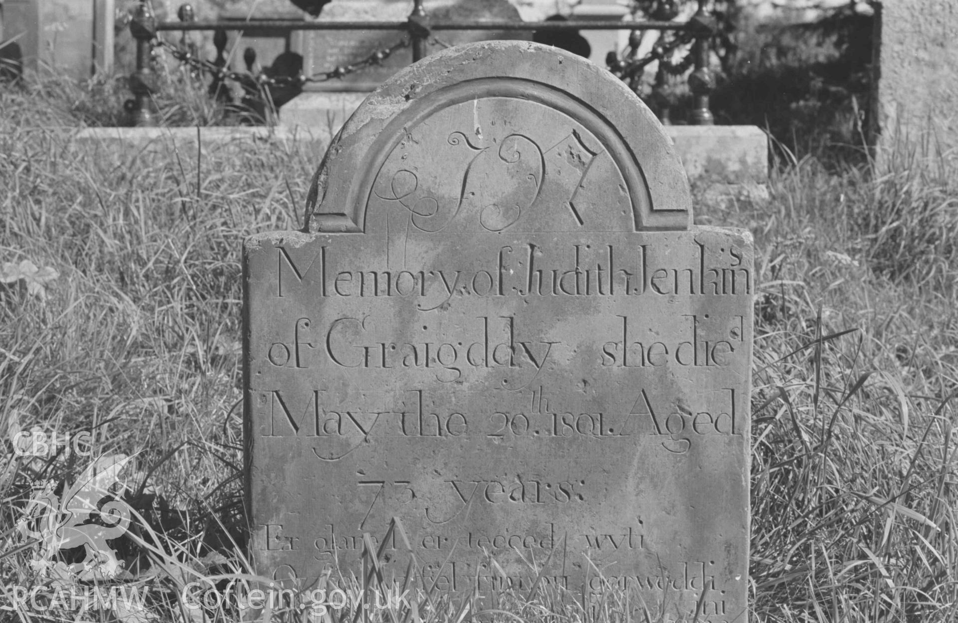 Digital copy of a black and white negative showing tombstones in the churchyard at Llanddewi-Brefi. Photographed by Arthur Chater on 22 August 1968. Grid Reference SN 664 553.