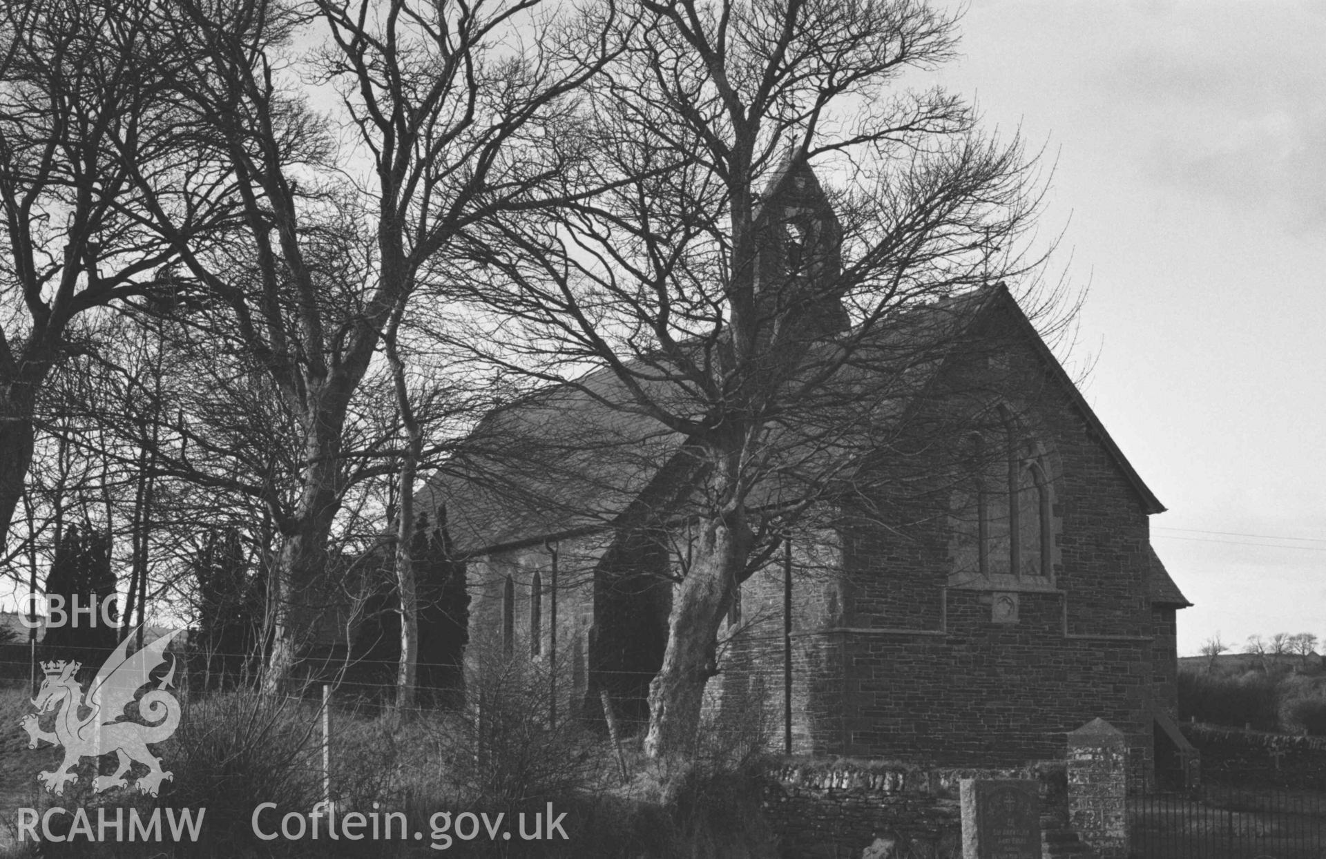 Digital copy of a black and white negative showing St Ursula's church, from the site of the old church across the lane in the old graveyard. Photographed by Arthur Chater on 30 December 1968. Looking north west from Grid Reference SN 5967 7051.