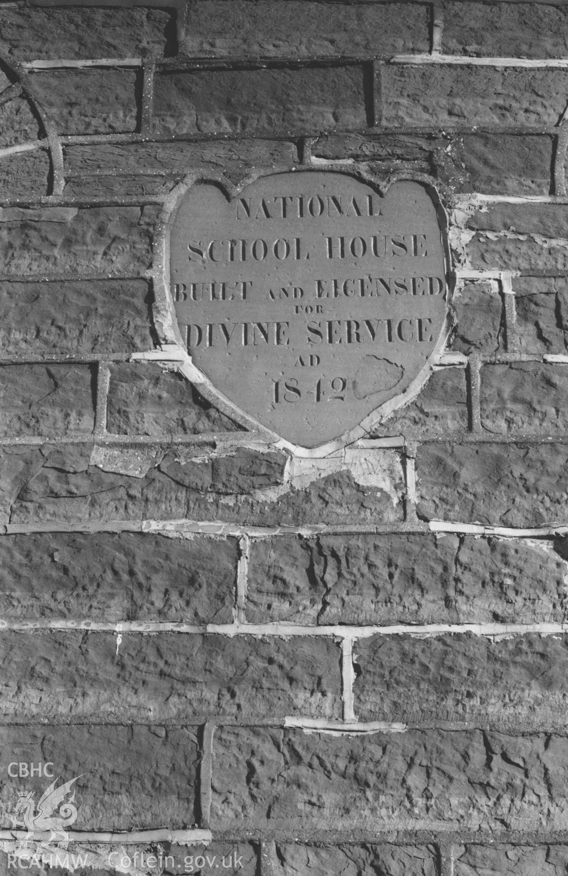 Digital copy of a black and white negative showing inscription on slate on the west front of the National School House, Borth. Photographed by Arthur Chater on 2 January 1969. Looking east from Grid Reference SN 6084 8749.