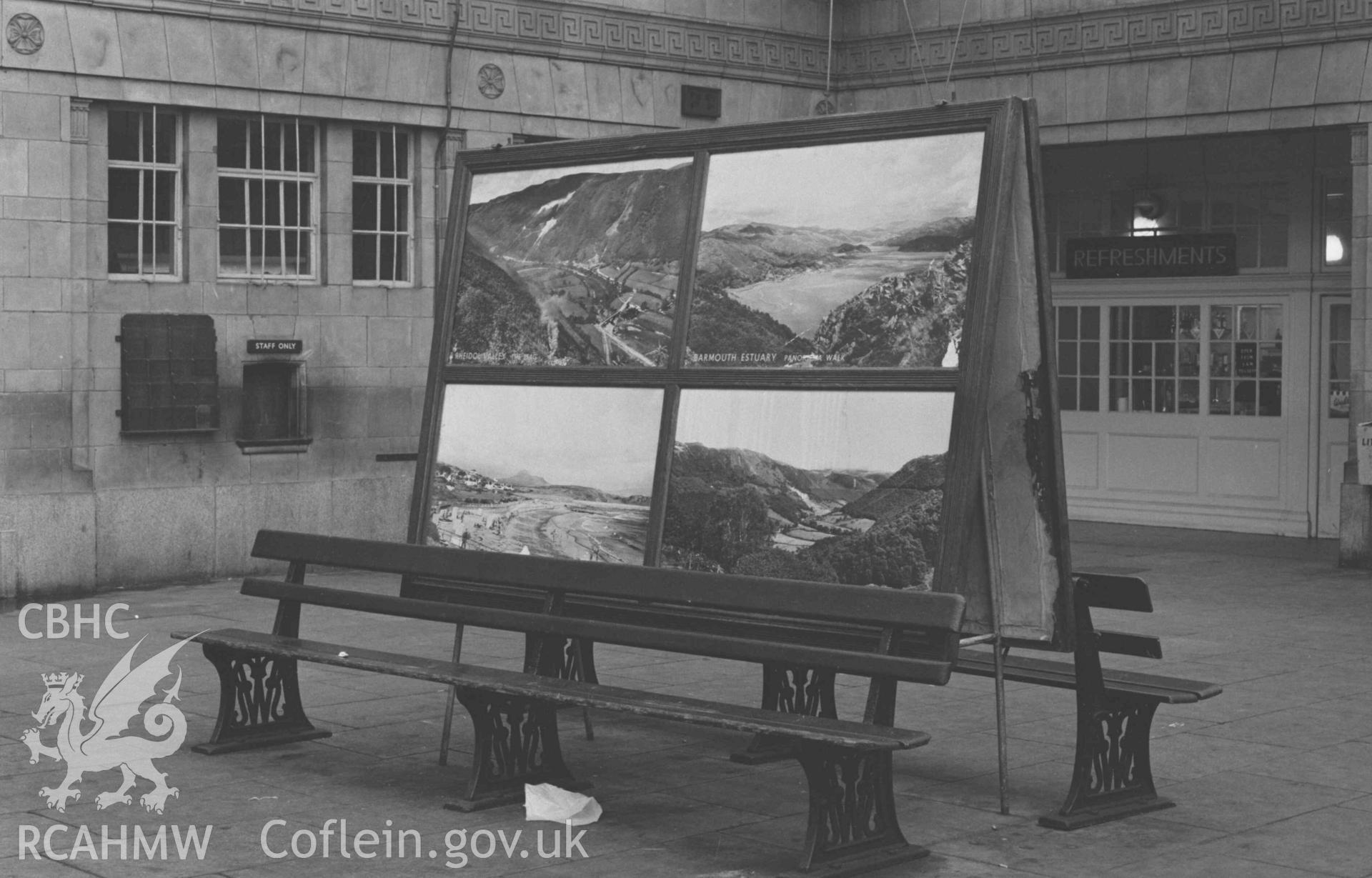 Digital copy of a black and white negative showing the exhibition case at Abersytwyth Railway Station. Photographed by Arthur Chater on 3 January 1969. Looking south east from Grid Reference SN 5852 8157.