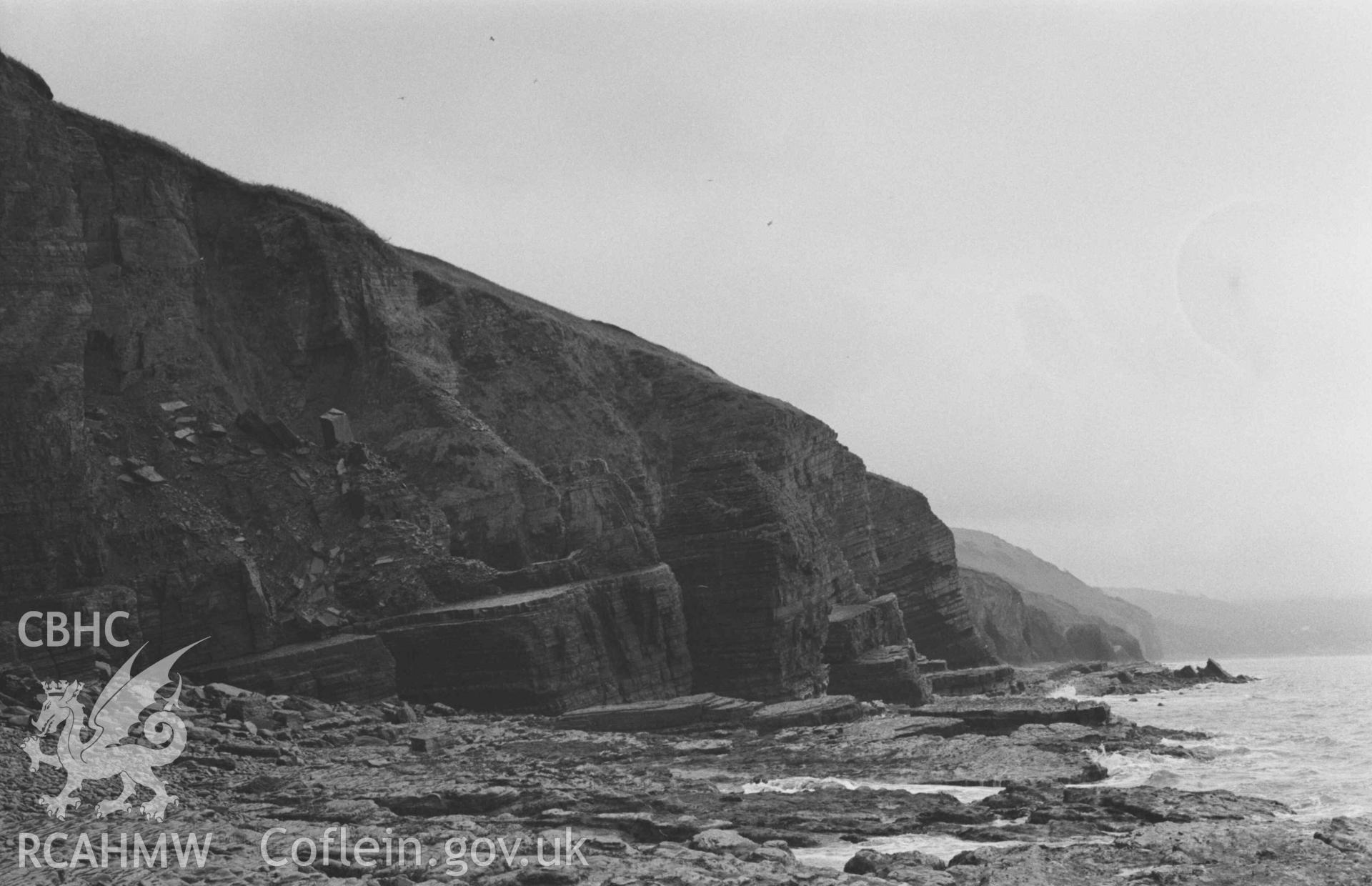 Digital copy of a black and white negative showing view down the coastfrom 300m west of the mouth of the Afon Gwinten, at low tide. Photographed by Arthur Chater on 3 January 1969. Looking south west from Grid Reference SN 4325 6132.
