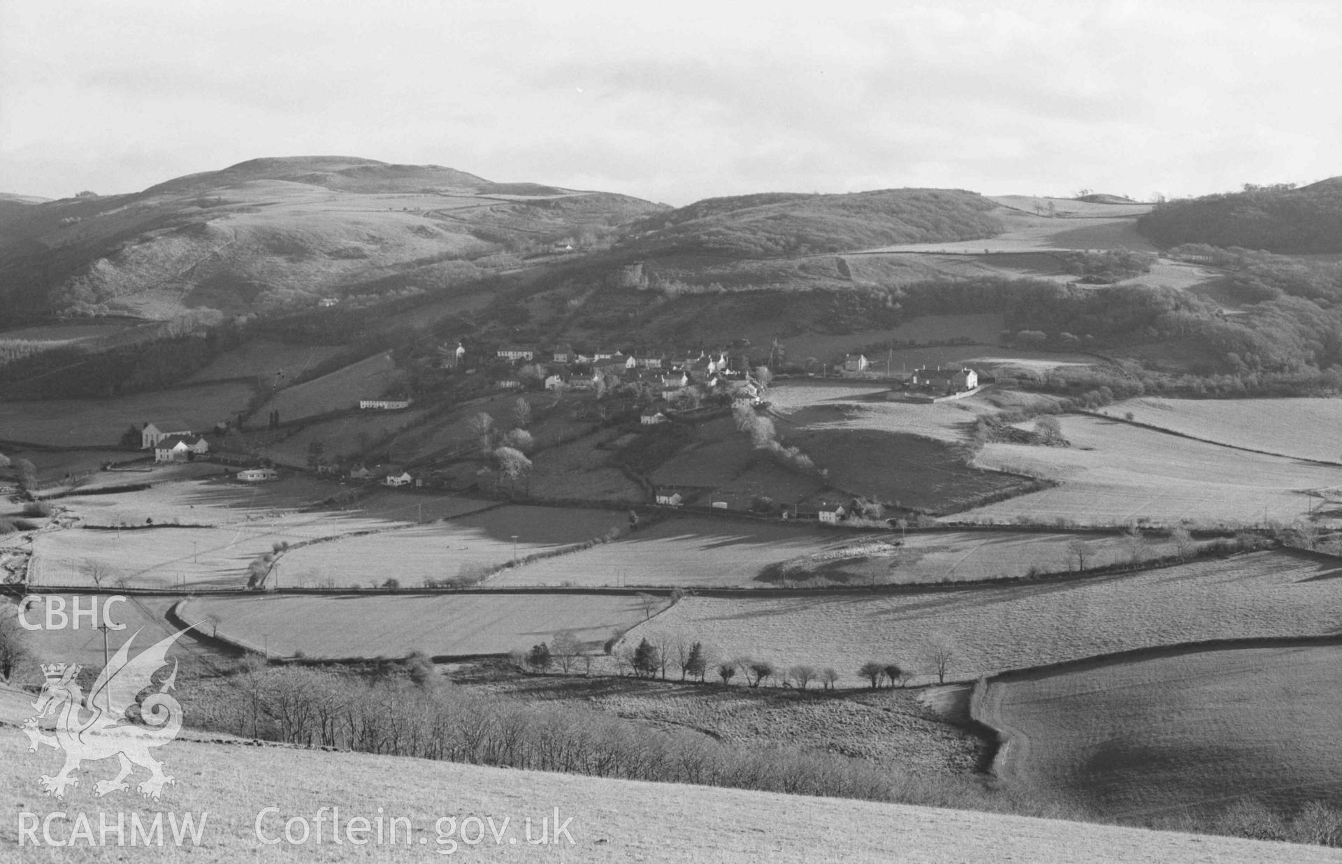 Digital copy of a black and white negative showing view from the lane above Coed Troed-y-Rhiw across the Melindwr valley to  Goginan (this and 60902 form a complete panorama). Photographed by Arthur Chater on 5 January 1969. Looking south east from Grid Reference SN 661 819.