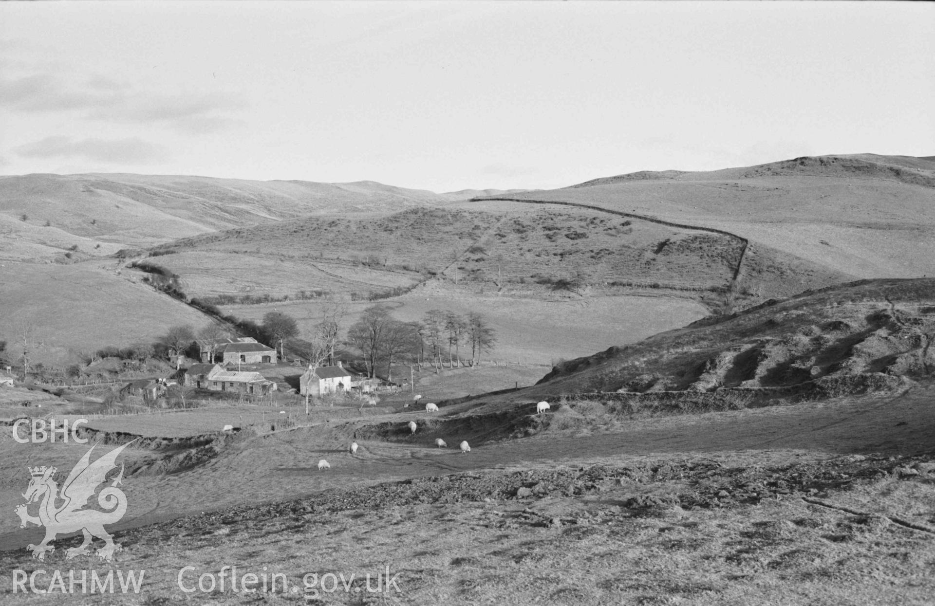 Digital copy of a black and white negative showing panorama of Castell Bwa Drain, with Bwa Drain farm on left and Rheidol Valley on right (photo 1 of 4). Photographed by Arthur Chater on 5 January 1969. Looking north east to south east from Grid Reference SN 712 795.