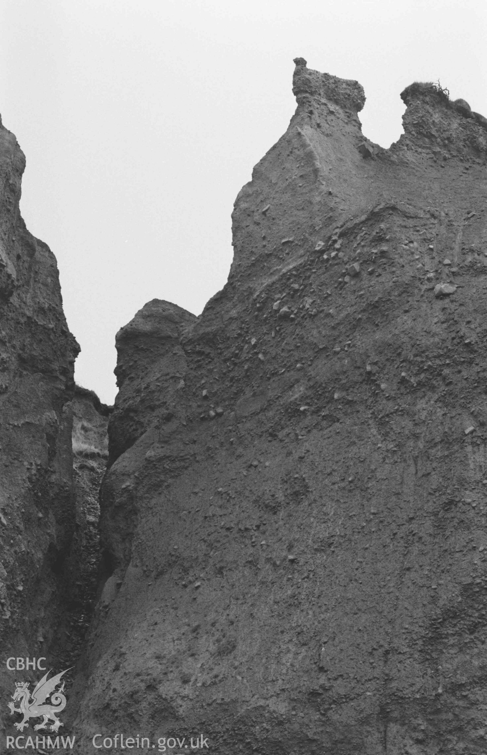 Digital copy of a black and white negative showing eroded boulder clay cliffs 100m north east of the mouth of the Afon Cwinten. Photographed by Arthur Chater on 3 January 1969. Looking south east from Grid Reference SN 436 614.