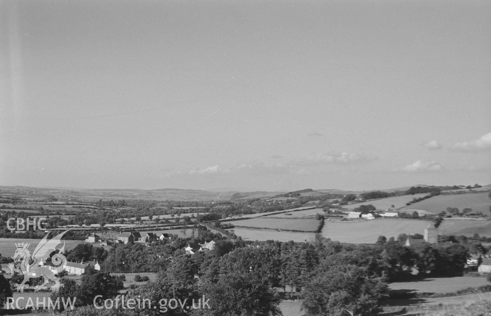 Digital copy of a black and white negative showing Llanddewi-Brefi from the road by the quarry above Troed-y-Rhiw. Photographed by Arthur Chater on 22 August 1968. Looking north east from Grid Reference SN 660 548.