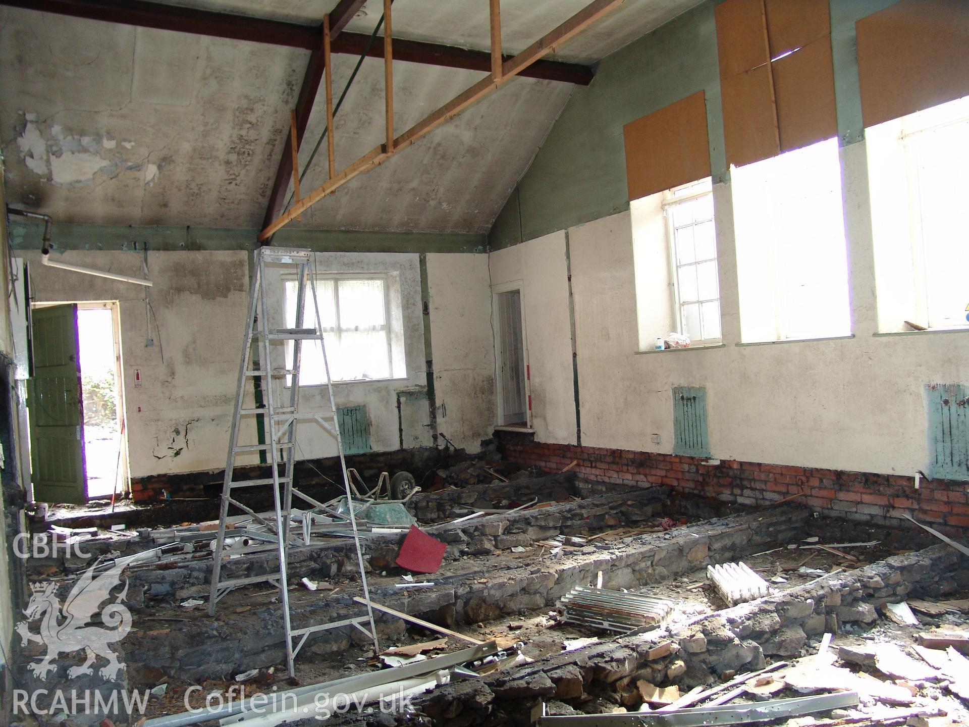 Photograph from a building recording survey: Zion Chapel, High Street, Newbridge, Gwent; internal view, of vestry /store area showing side entry door and internal toilet to rear. Carried out by A. P. A. C. Ltd. in September 2008.