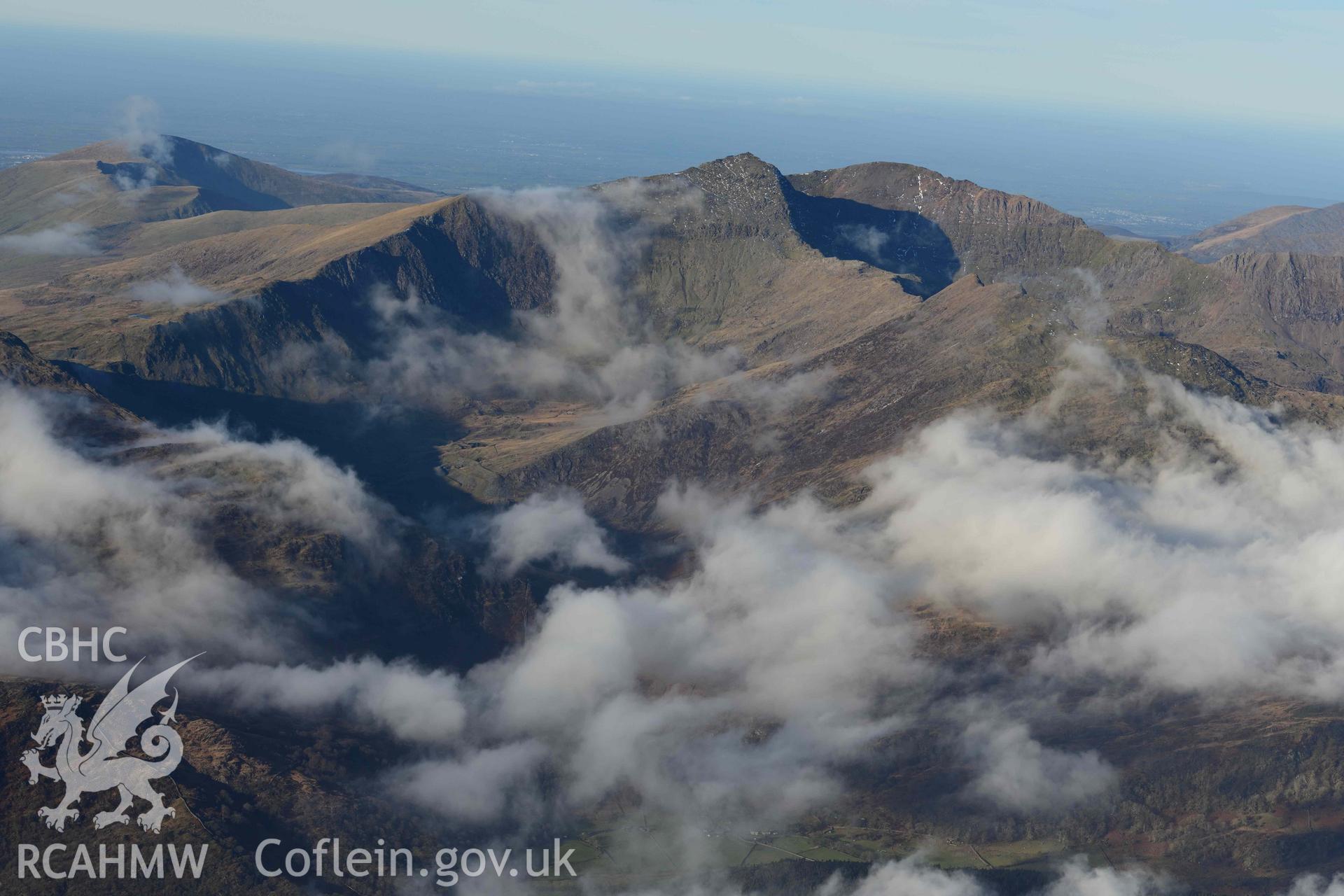 Oblique aerial photograph of Snowdon mountain landscape, taken from the south east during the Royal Commission’s programme of archaeological aerial reconnaissance by Toby Driver on 12th January 2022