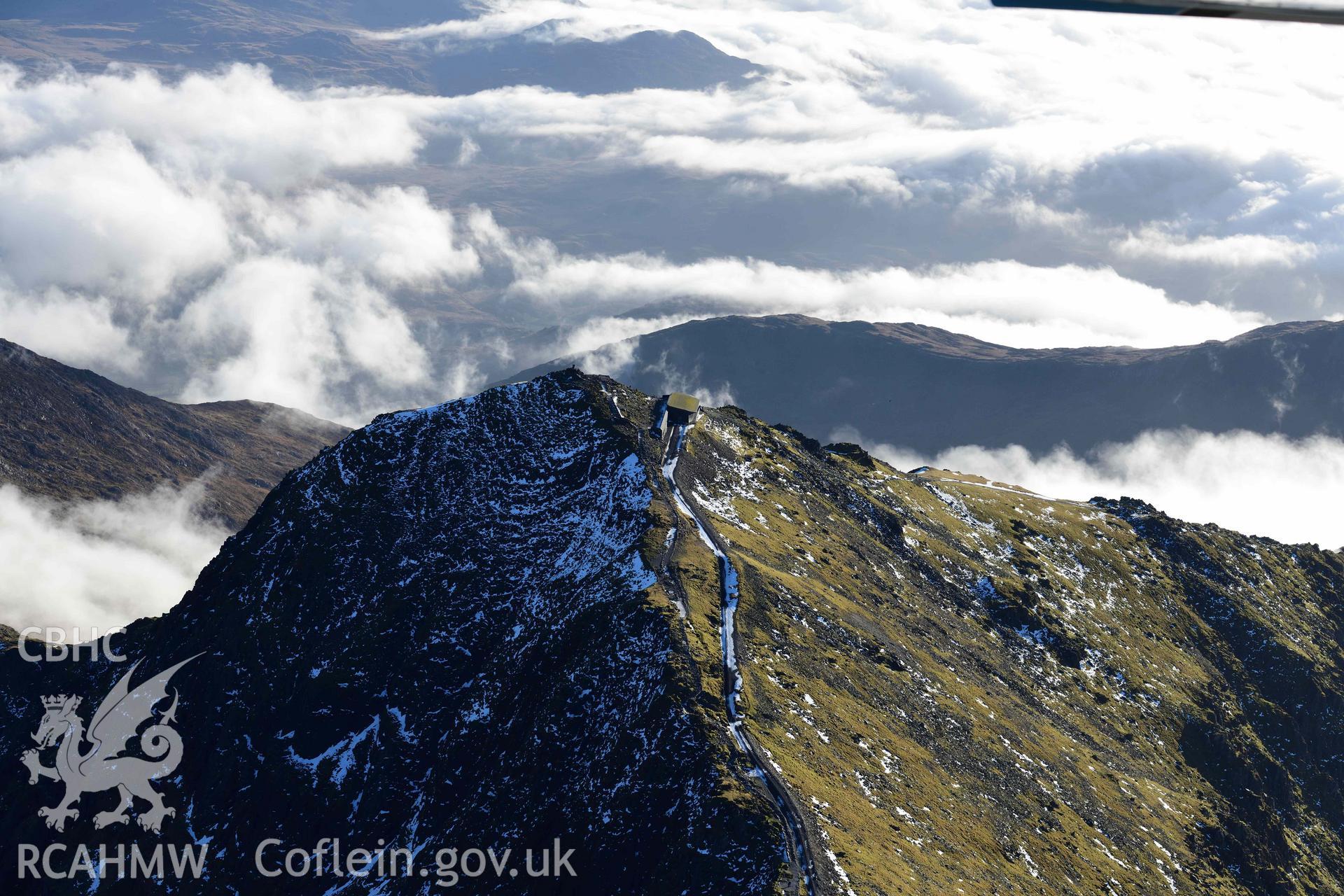 Oblique aerial photograph of Snowdon summit and mountain landscape, taken from the north during the Royal Commission’s programme of archaeological aerial reconnaissance by Toby Driver on 12th January 2022