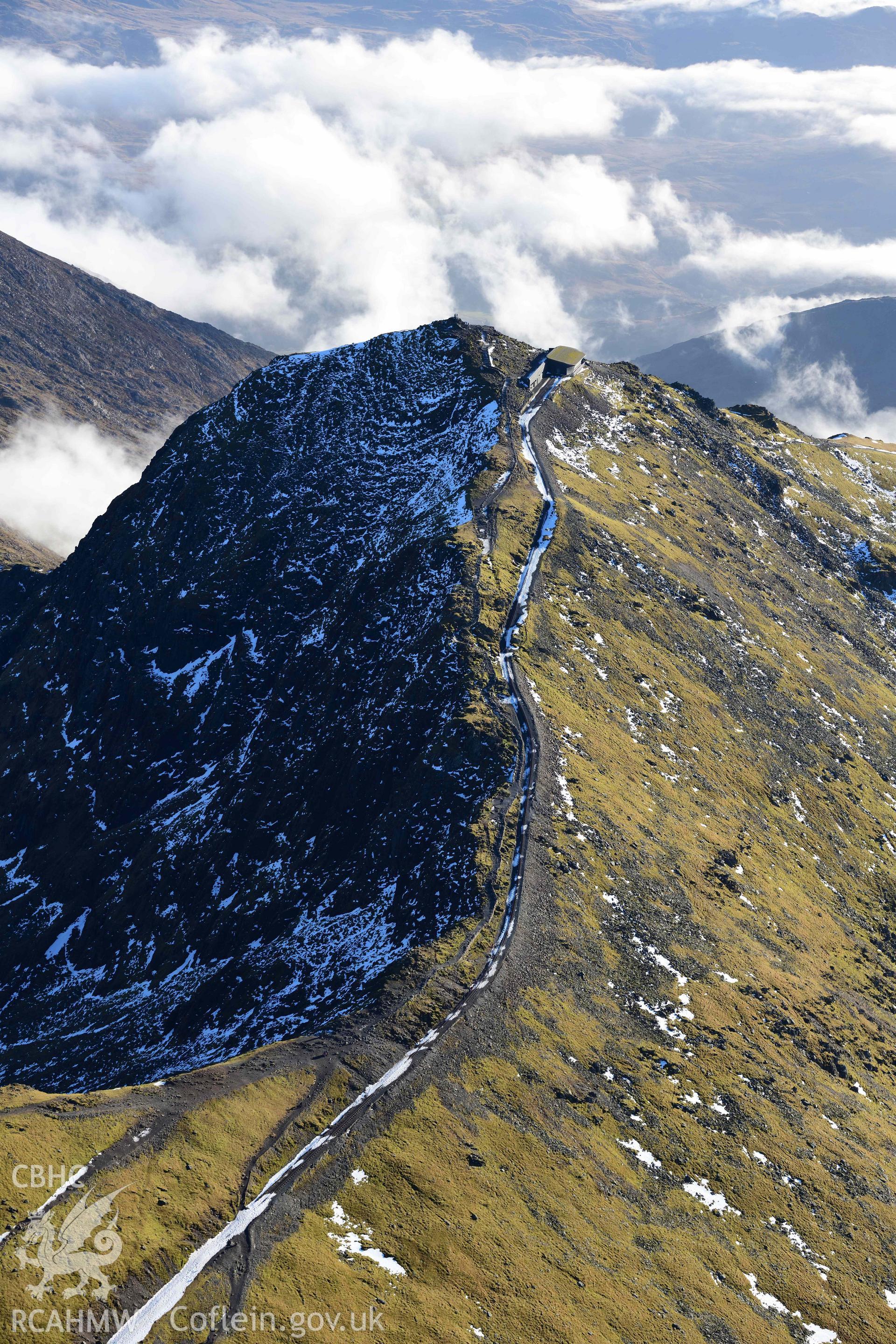Oblique aerial photograph showing view from the north towards Snowdon summit and railway, taken during the Royal Commission’s programme of archaeological aerial reconnaissance by Toby Driver on 12th January 2022