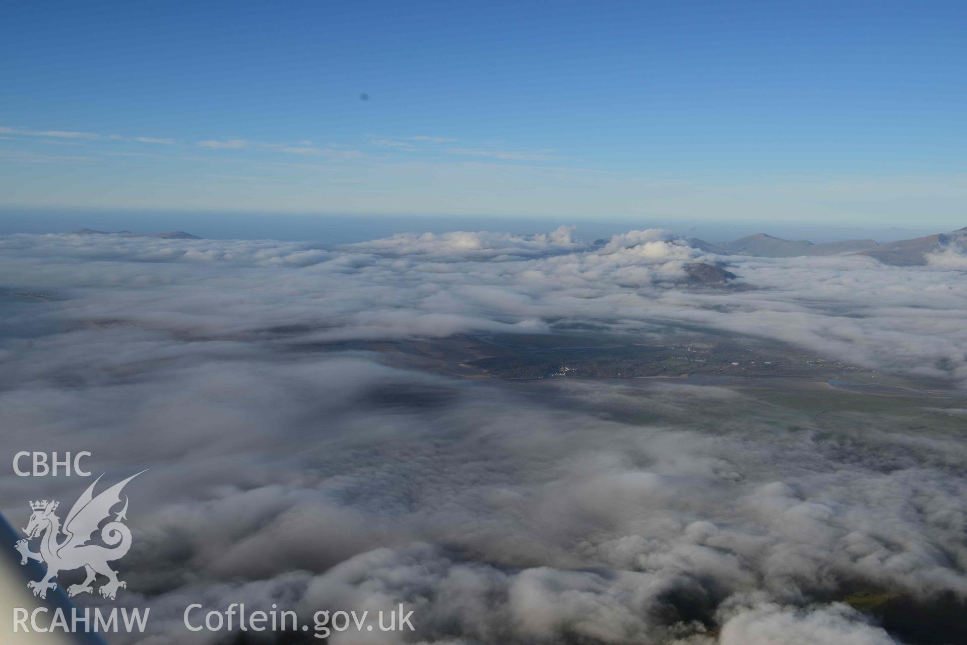Oblique aerial photograph of Portmeirion village with cloud inversion, taken from the south east during the Royal Commission’s programme of archaeological aerial reconnaissance by Toby Driver on 12th January 2022