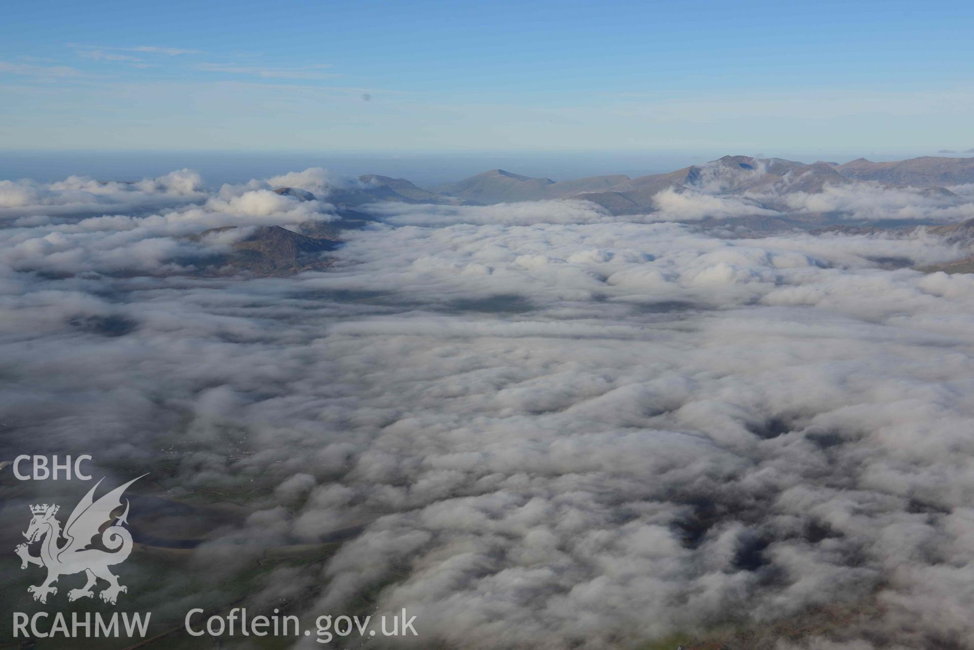 Oblique aerial photograph of Portmeirion village with cloud inversion, taken from the south east during the Royal Commission’s programme of archaeological aerial reconnaissance by Toby Driver on 12th January 2022