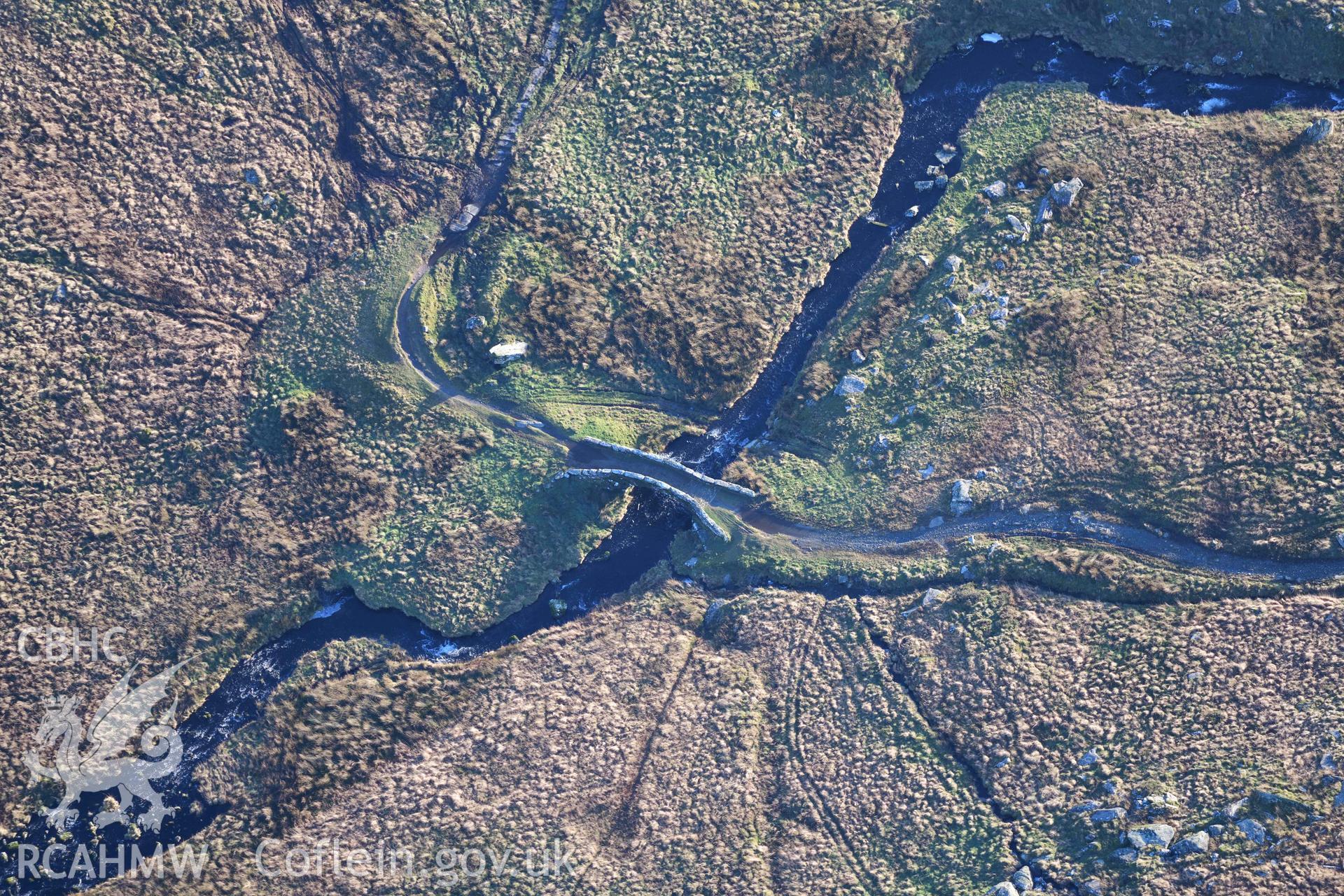 Oblique aerial photograph of Pont Scethin packhorse bridge taken during the Royal Commission’s programme of archaeological aerial reconnaissance by Toby Driver on 12th January 2022