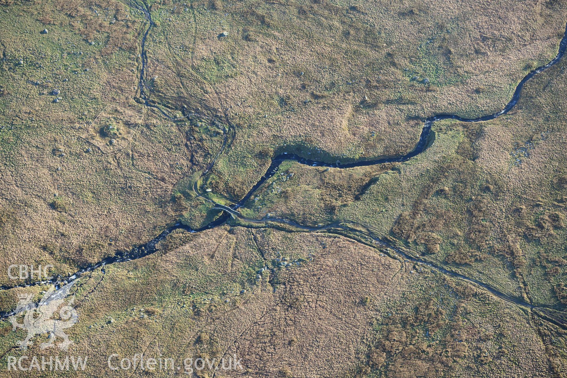 Oblique aerial photograph of Pont Scethin packhorse bridge taken during the Royal Commission’s programme of archaeological aerial reconnaissance by Toby Driver on 12th January 2022