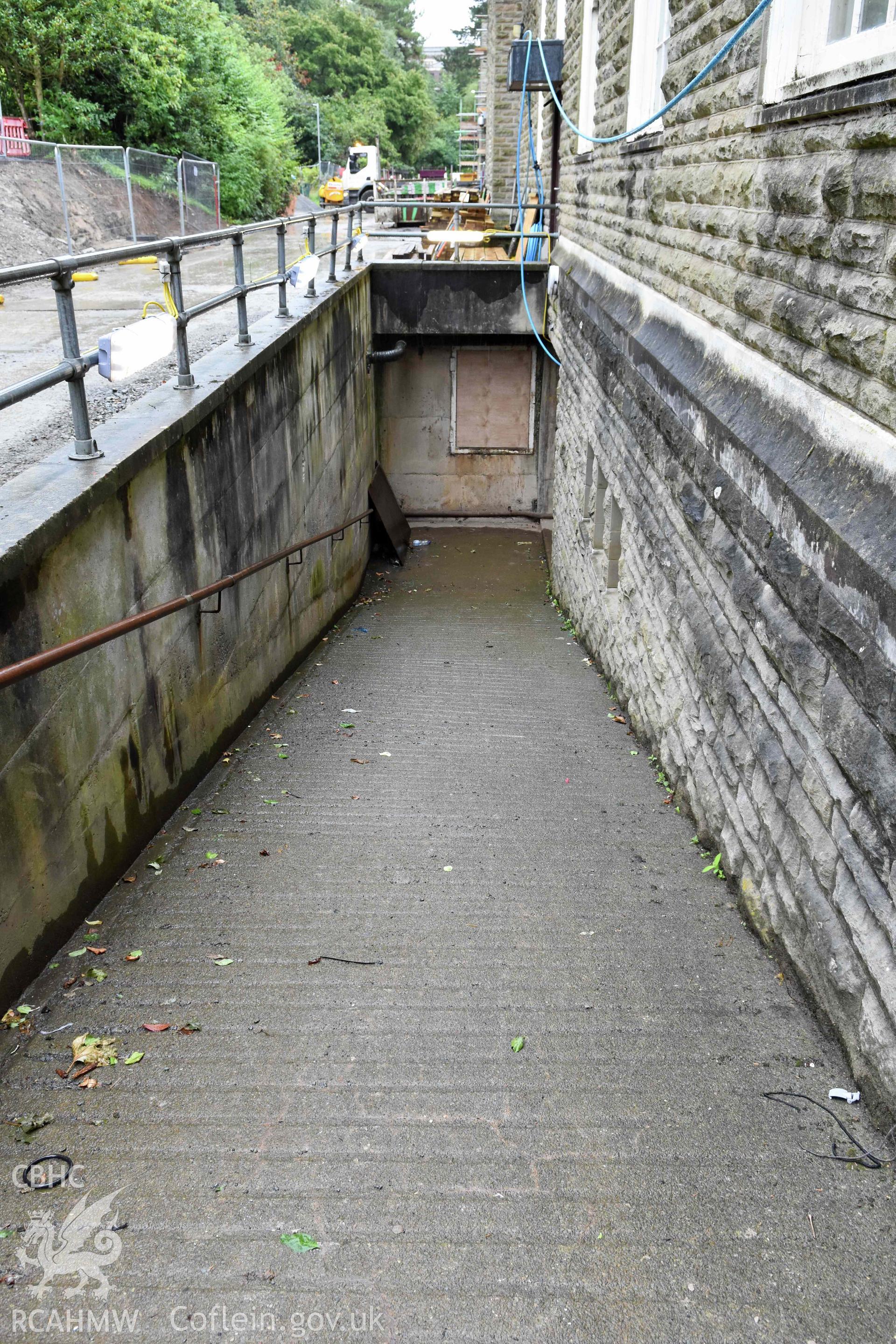 Ramp down to basement level on east side of building.