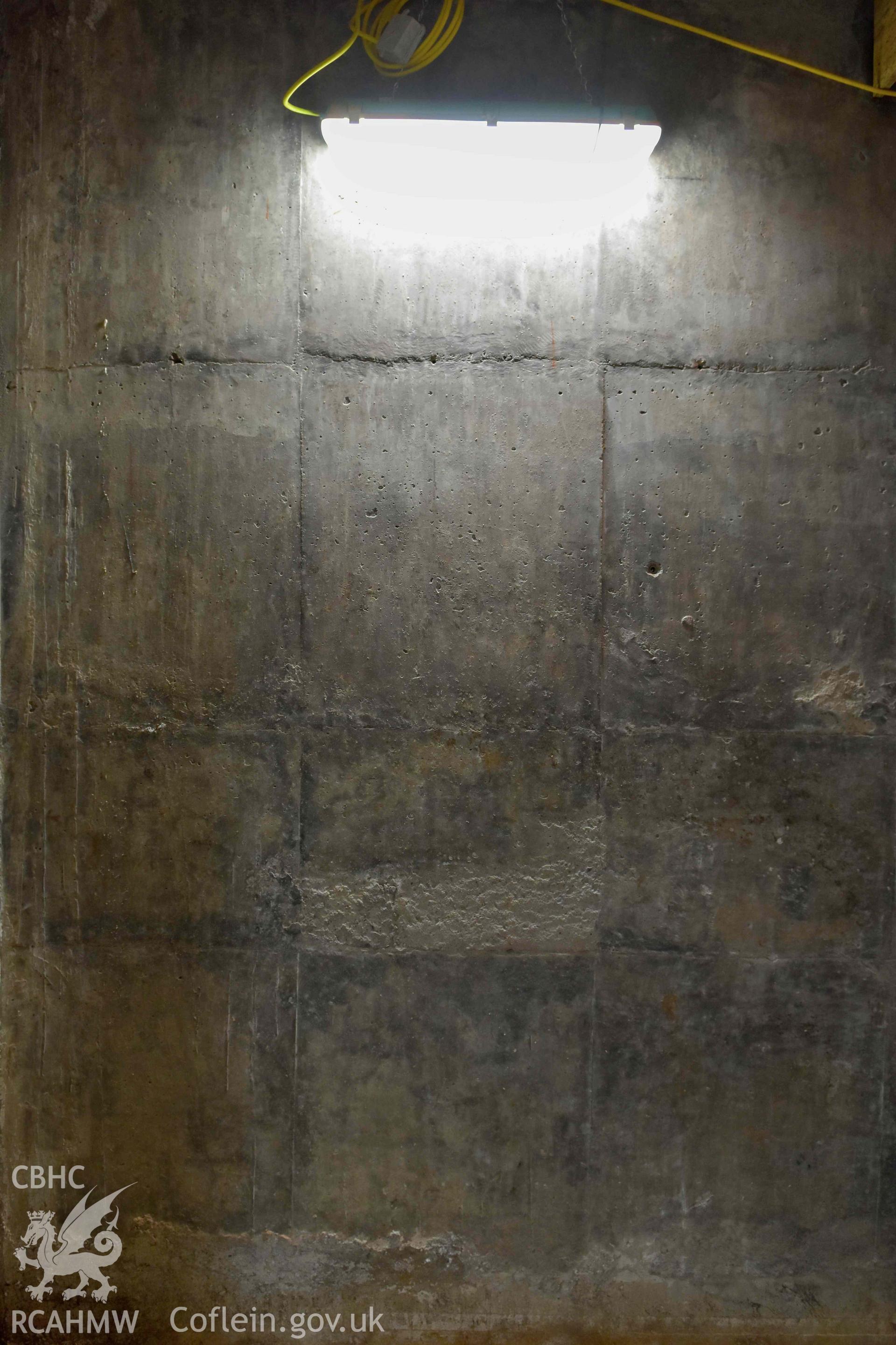 Basement room on east side of building, detail of concrete wall.