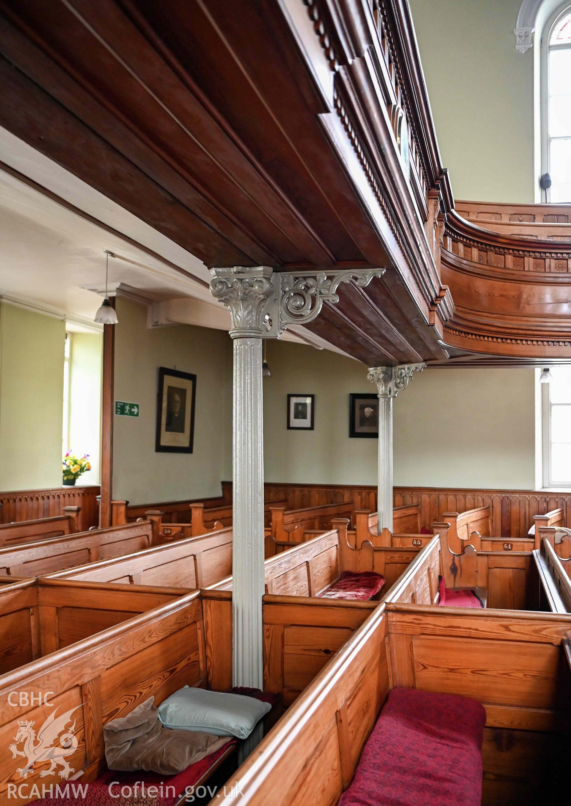 Capel Moreia interior, pews and gallery support at west end of the auditorium.