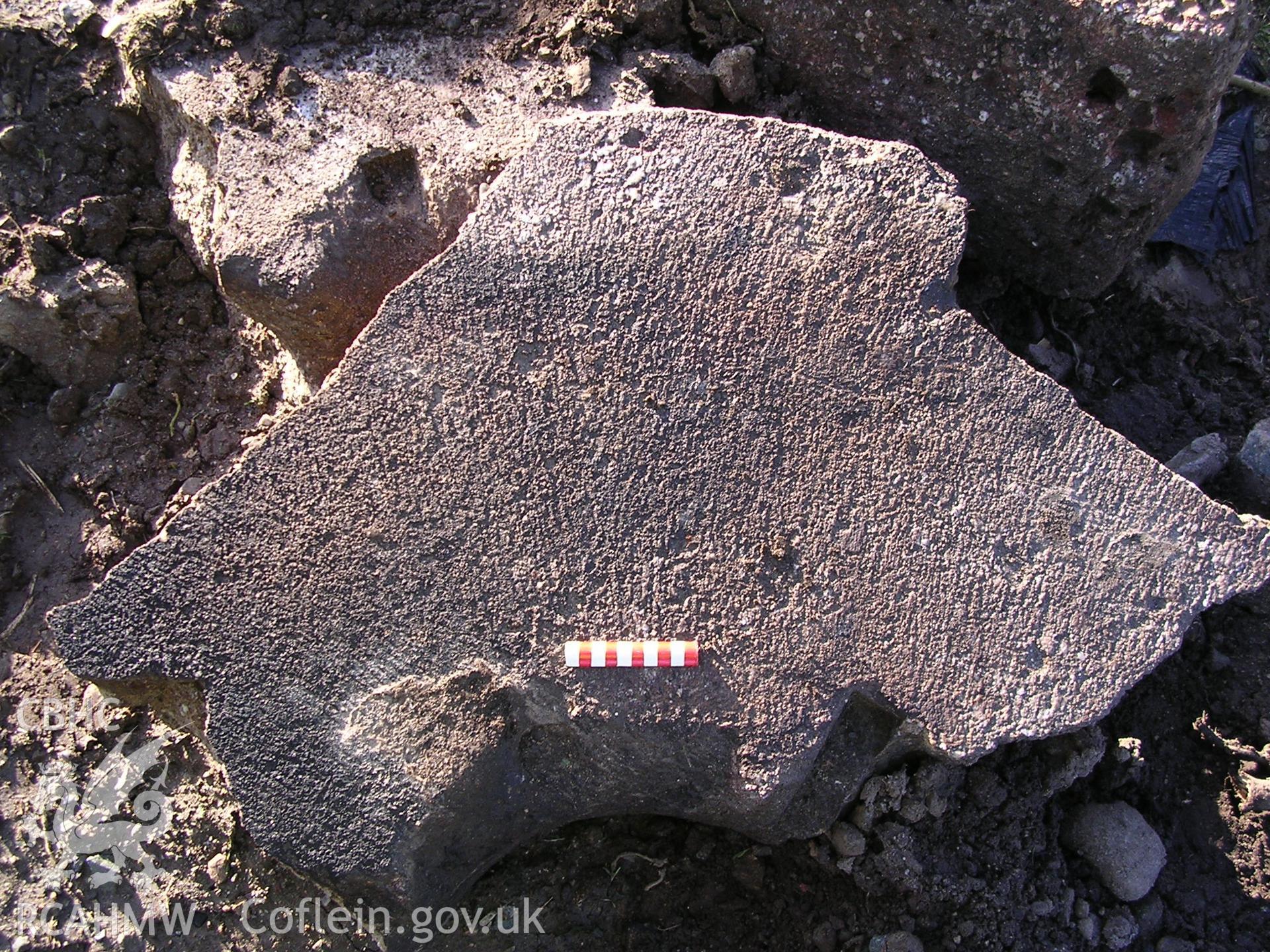 Digital photograph showing part of a millstone.