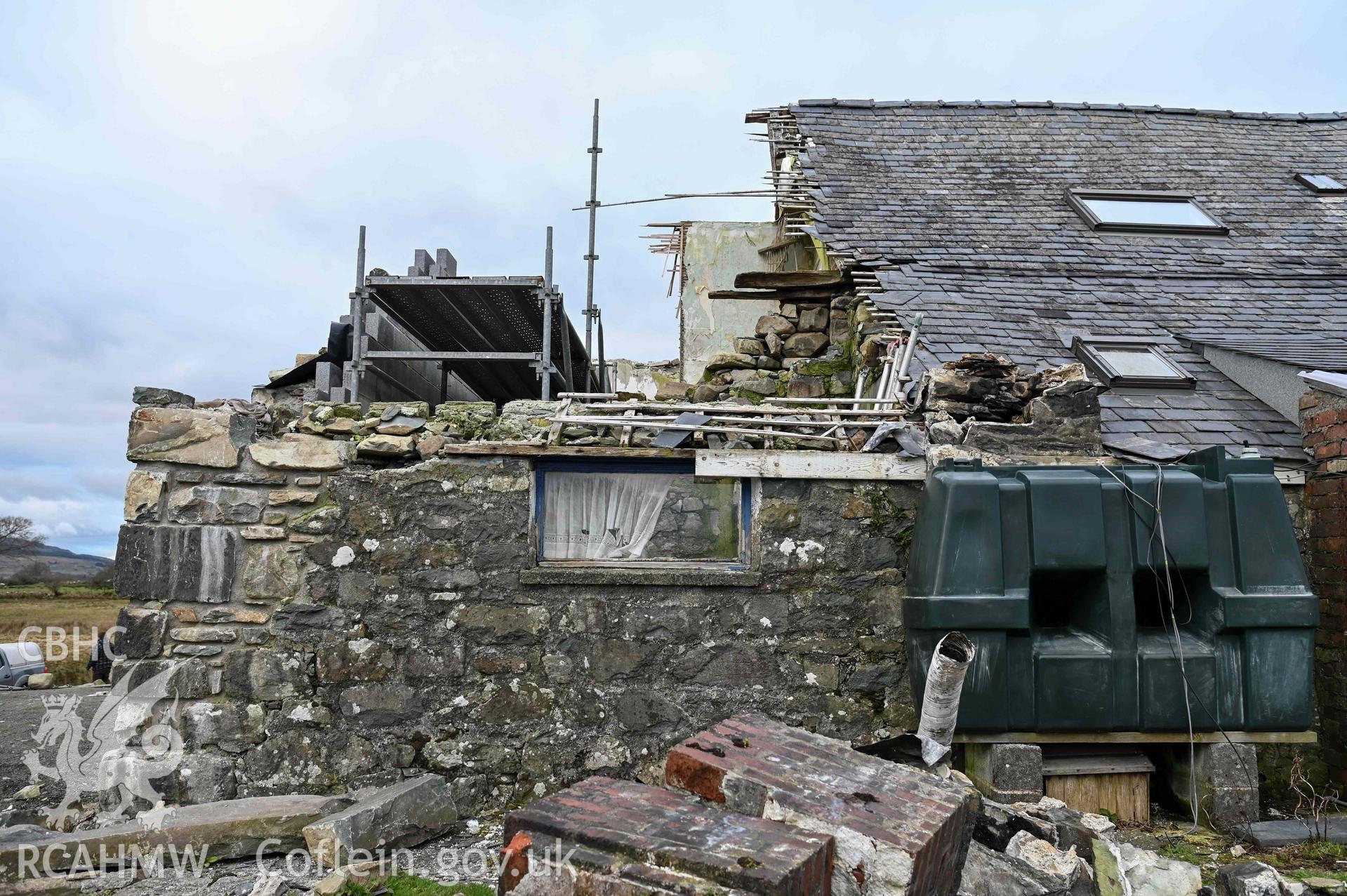Tyddyn Mawr, exterior of western bay of farmhouse under reconstruction from the south.