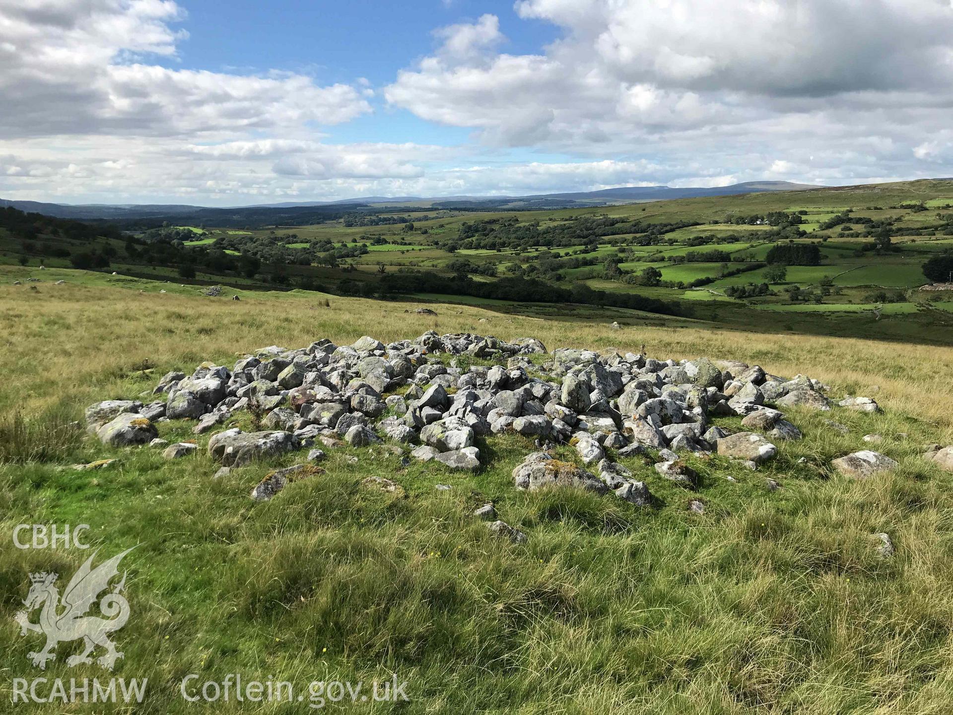 Digital photograph showing general view of cairn with kerb at Pant Sychbant. Produced by Paul Davis in 2020