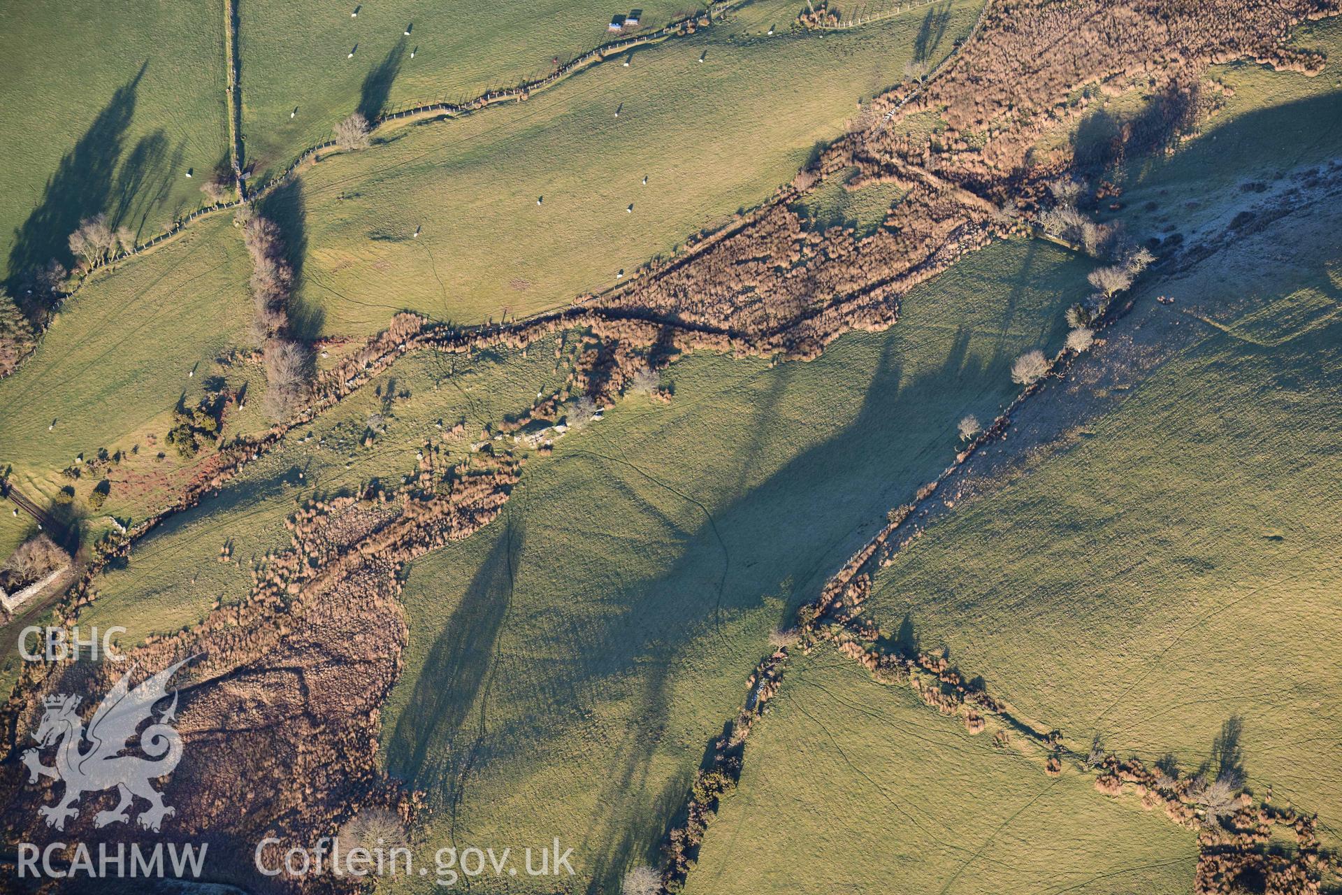 Oblique aerial photograph of Tomen y Mur practice works and annex to the north west. Taken during the Royal Commission’s programme of archaeological aerial reconnaissance by Toby Driver on 17th January 2022