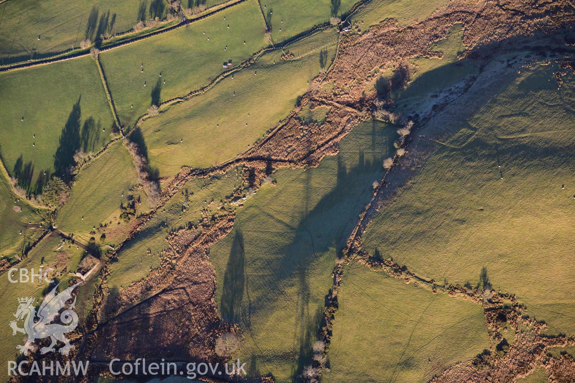 Oblique aerial photograph of Tomen y Mur practice works and annex to the north west. Taken during the Royal Commission’s programme of archaeological aerial reconnaissance by Toby Driver on 17th January 2022