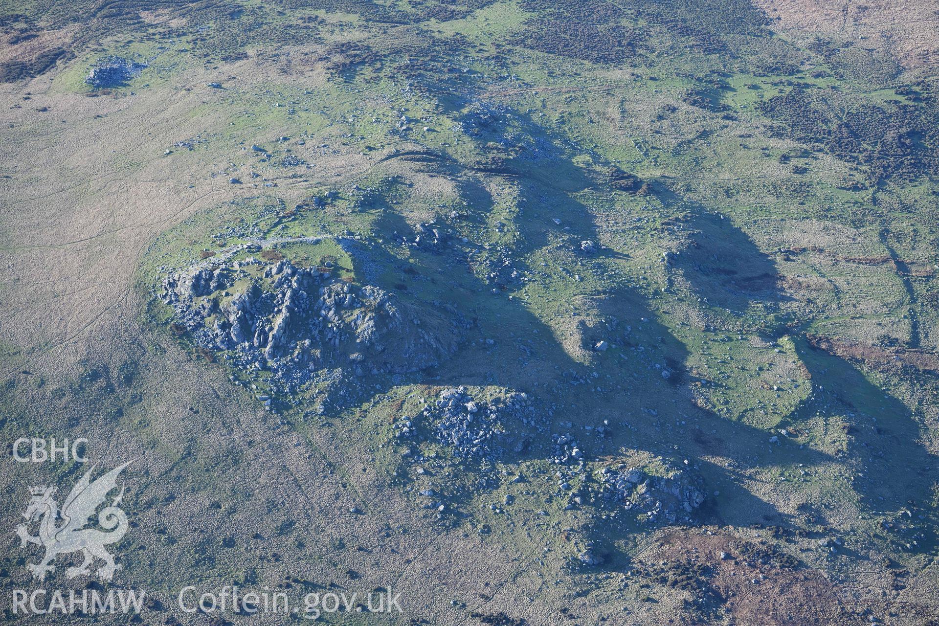 Oblique aerial photograph showing view from the north east of Carn Alw hillfort taken during the Royal Commission’s programme of archaeological aerial reconnaissance by Toby Driver on 17th January 2022