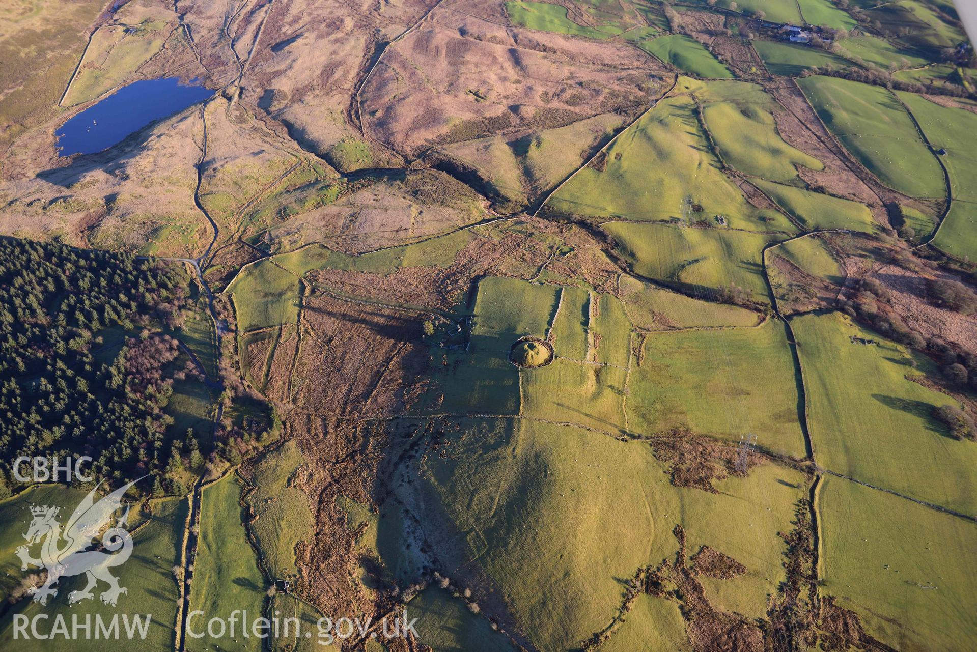 Oblique aerial photograph of Tomen y Mur Roman fort and earthwork complex. Taken during the Royal Commission’s programme of archaeological aerial reconnaissance by Toby Driver on 17th January 2022