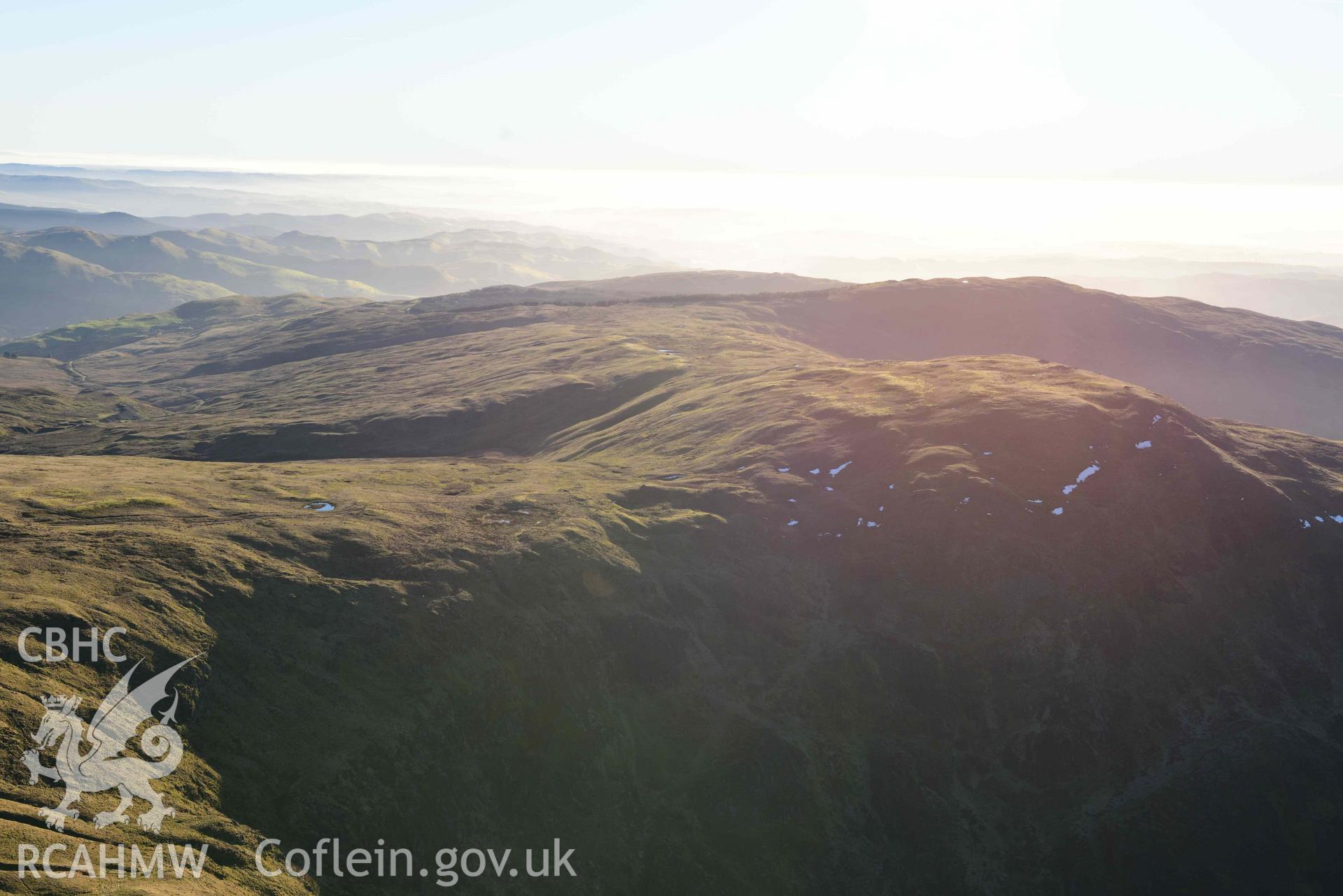Oblique aerial photograph showing wide view from the north of Pen Plynlimon Fawr cairn cemetery. Taken during the Royal Commission’s programme of archaeological aerial reconnaissance by Toby Driver on 17th January 2022