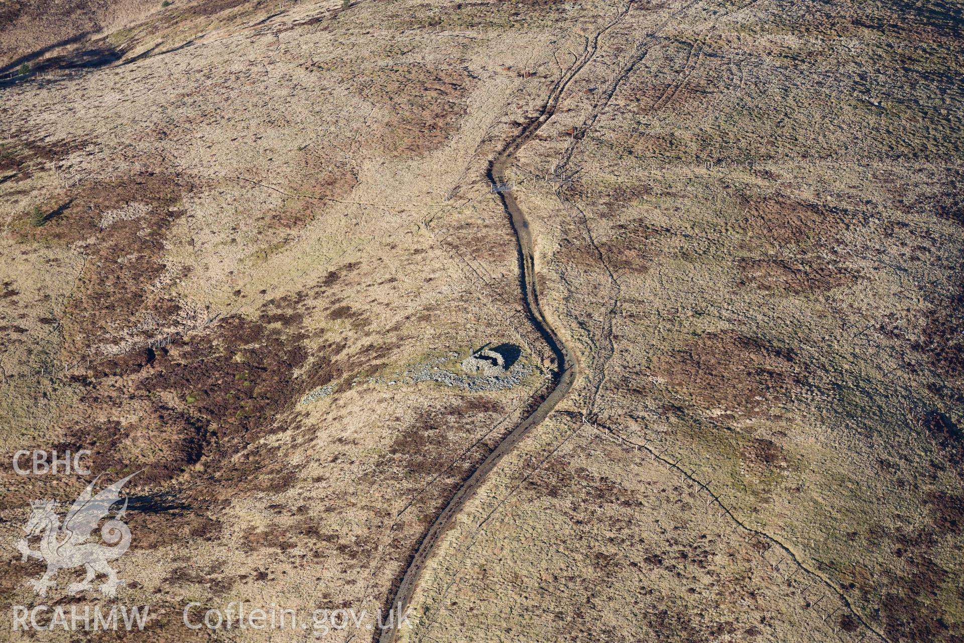 Oblique aerial photograph of Pen y Garn round cairn taken during the Royal Commission’s programme of archaeological aerial reconnaissance by Toby Driver on 17th January 2022