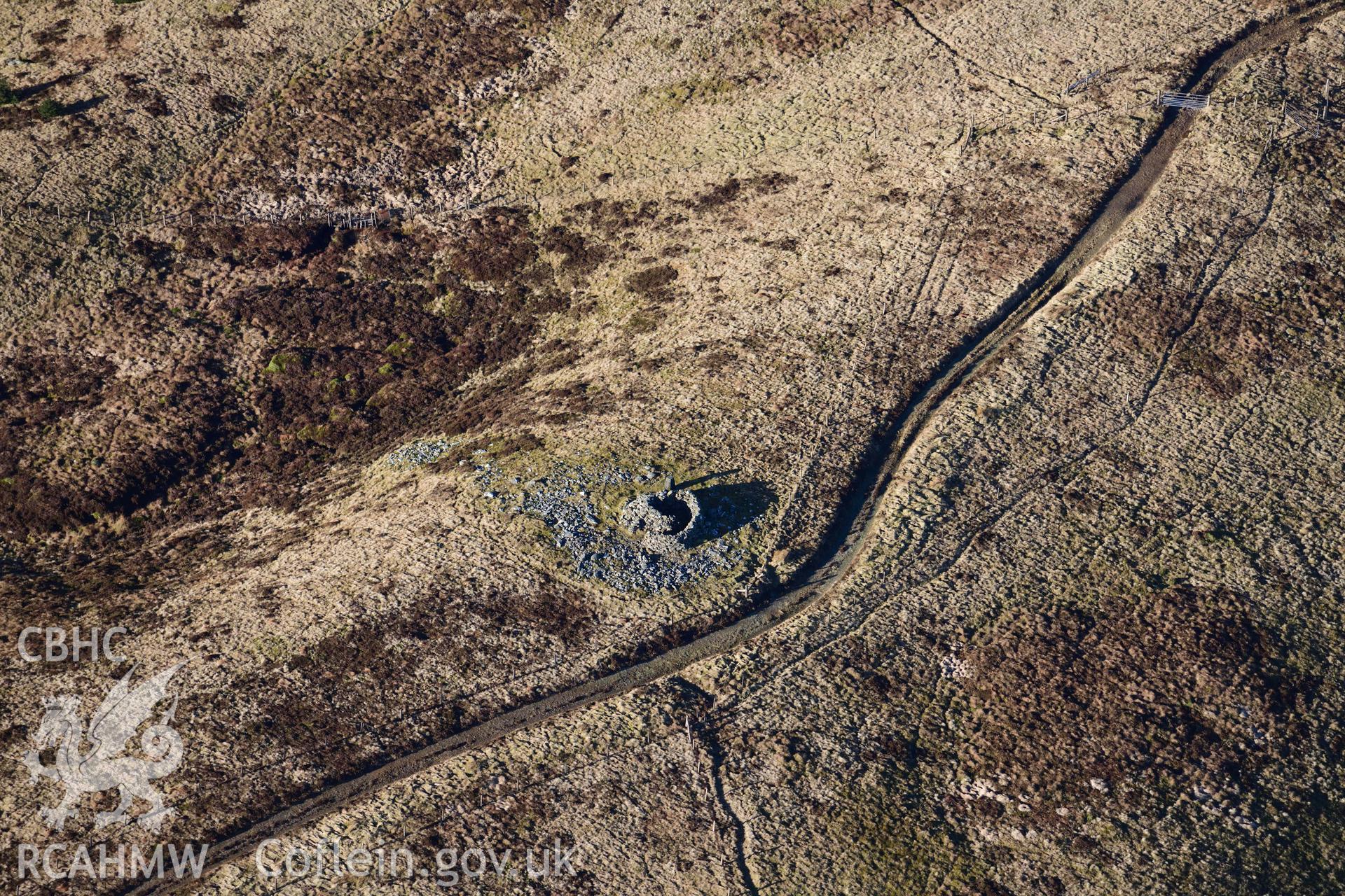 Oblique aerial photograph of Pen y Garn round cairn taken during the Royal Commission’s programme of archaeological aerial reconnaissance by Toby Driver on 17th January 2022