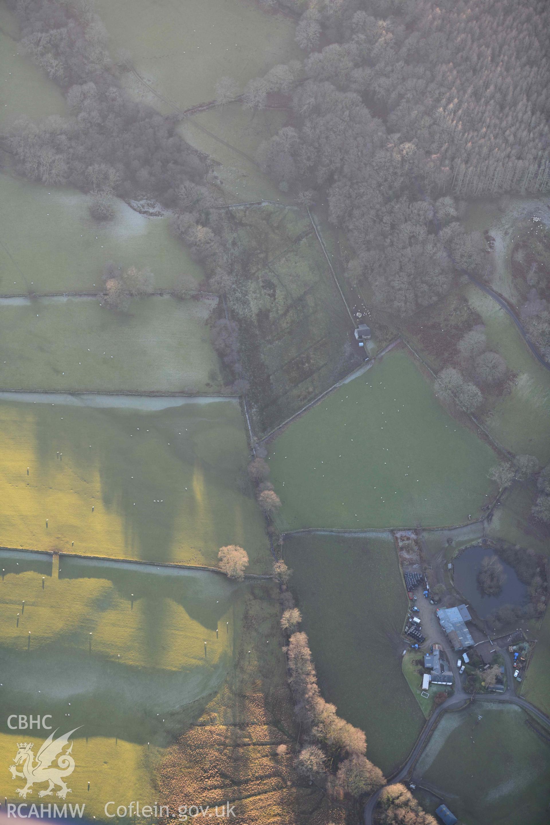 Oblique aerial photograp of Tyddyn Bach round barrow taken during the Royal Commission’s programme of archaeological aerial reconnaissance by Toby Driver on 17th January 2022