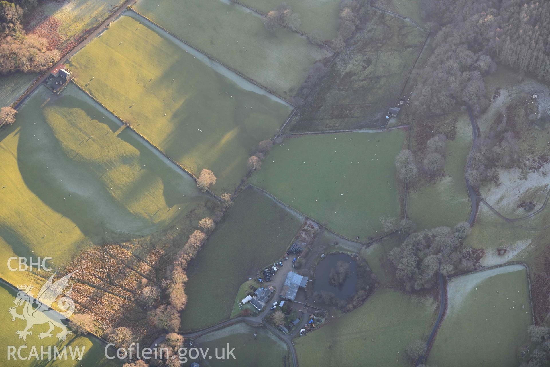 Oblique aerial photograp of Tyddyn Bach round barrow taken during the Royal Commission’s programme of archaeological aerial reconnaissance by Toby Driver on 17th January 2022