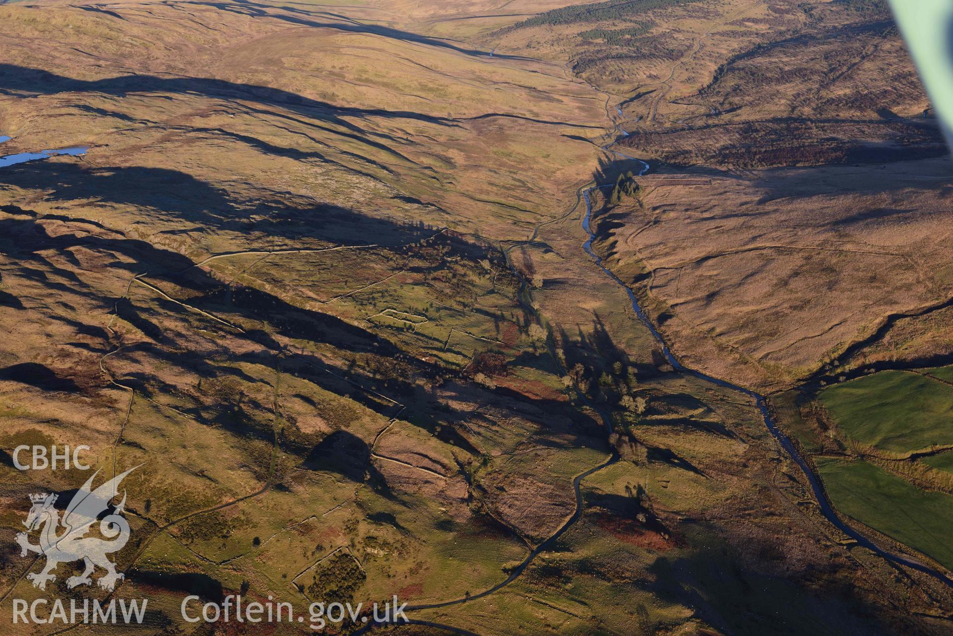 Oblique aerial photograph showing landscape view of Bronaber firing range, looking north east. Taken during the Royal Commission’s programme of archaeological aerial reconnaissance by Toby Driver on 17th January 2022