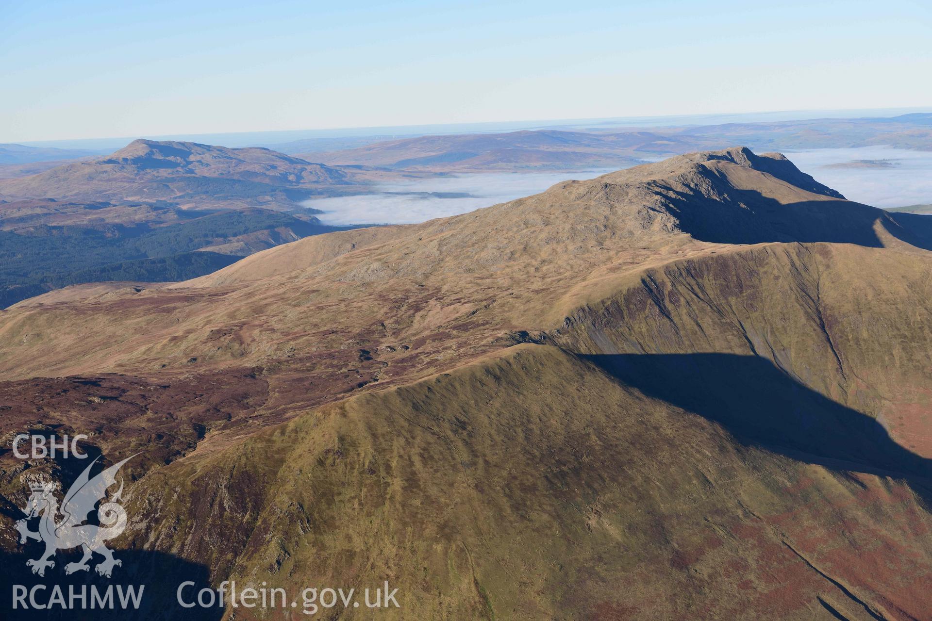 Oblique aerial photograph showing the winter mountain landscape of Aran Fawddwy. Taken from the south west over Gwaun y Llwyni during the Royal Commission’s programme of archaeological aerial reconnaissance by Toby Driver on 17th January 2022