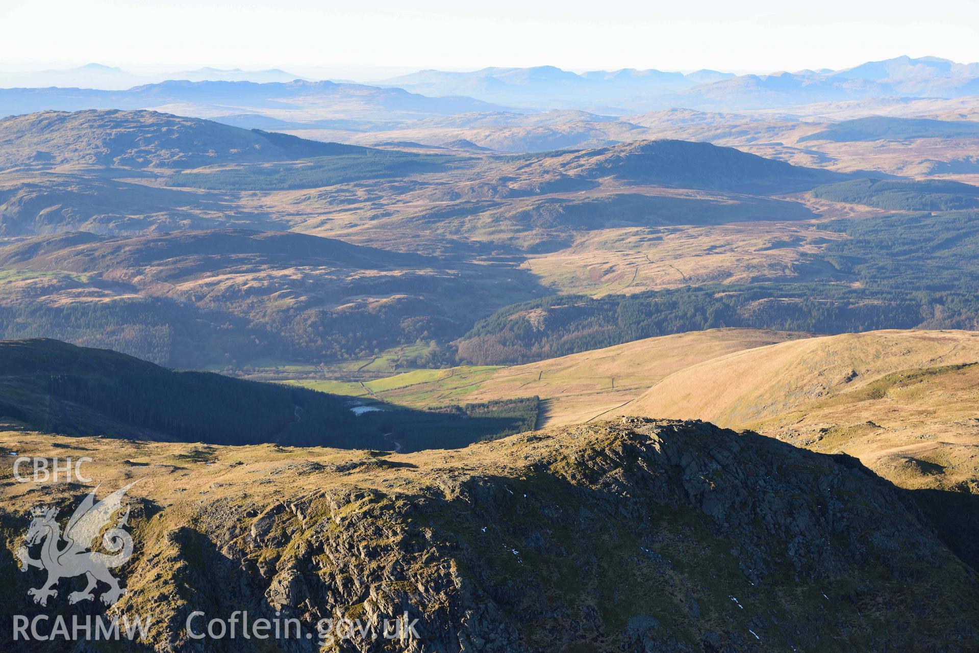 Oblique aerial photograph showing the winter mountain landscape of Aran Fawddwy, looking north west over the summit ridge. Taken during the Royal Commission’s programme of archaeological aerial reconnaissance by Toby Driver on 17th January 2022
