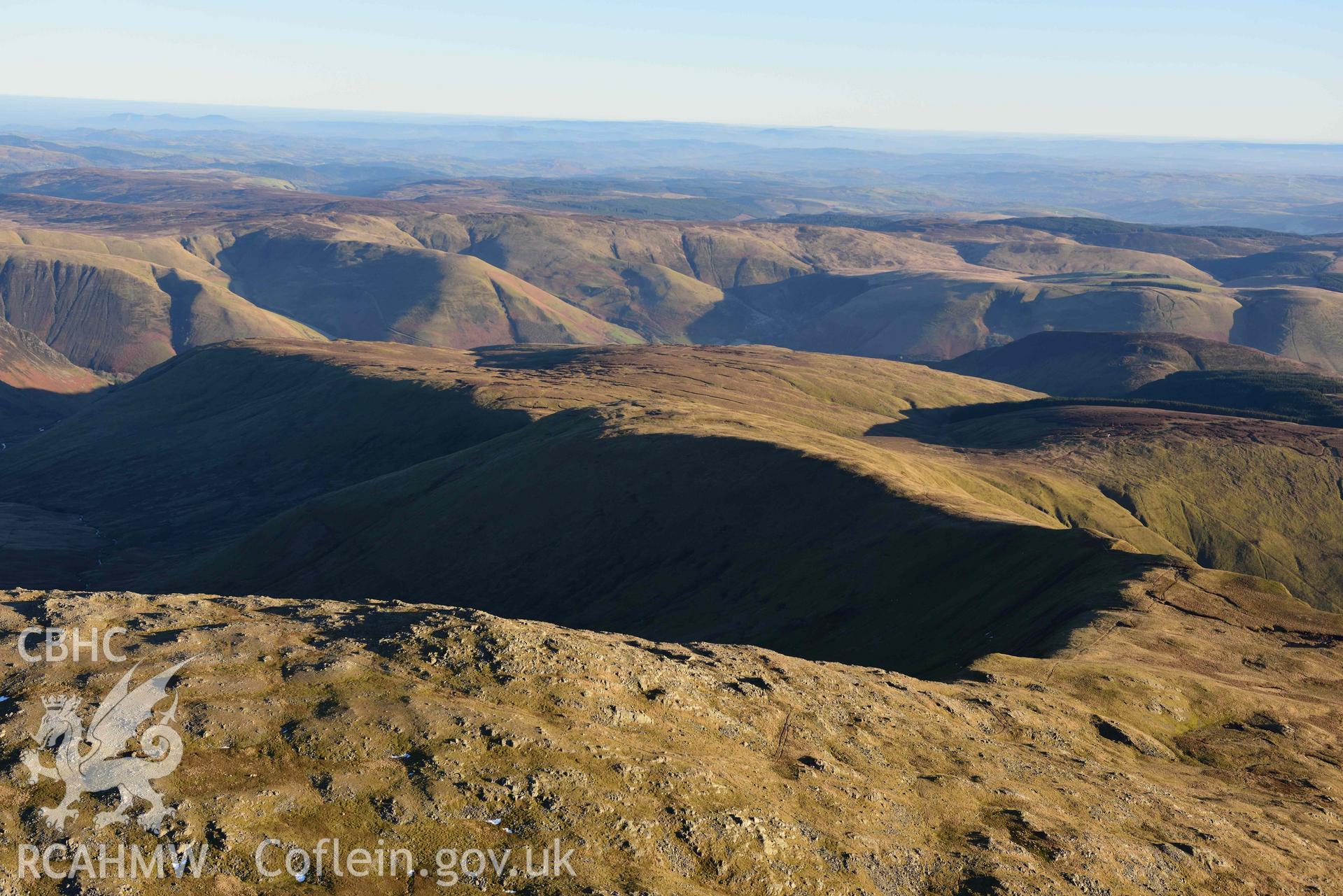 Oblique aerial photograph showing the winter mountain landscape of Aran Fawddwy, looking south over Drws Bach ridge. Taken during the Royal Commission’s programme of archaeological aerial reconnaissance by Toby Driver on 17th January 2022