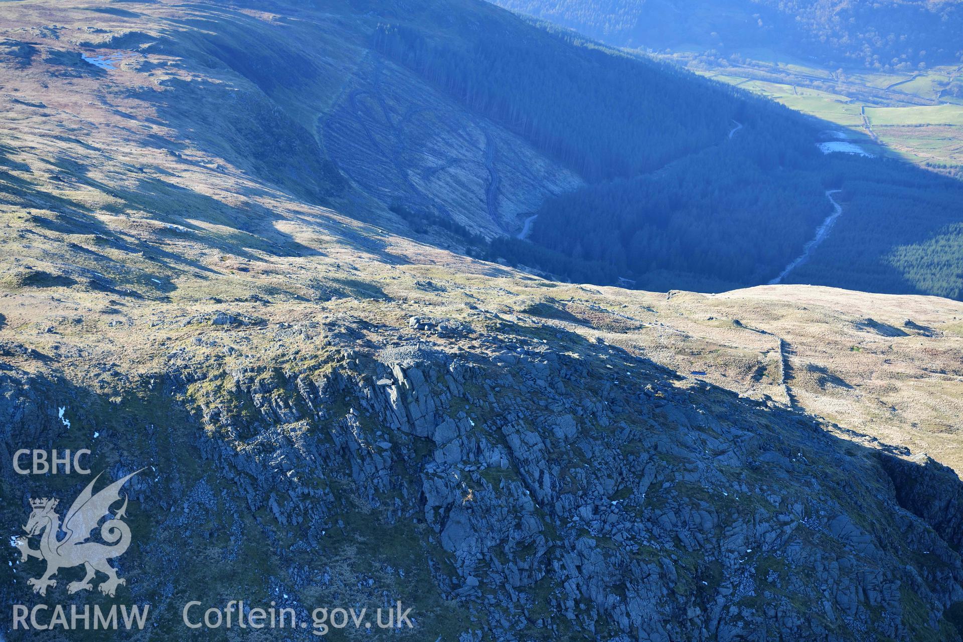 Oblique aerial photograph of Aran Fawddwy cairn and trig point taken during the Royal Commission’s programme of archaeological aerial reconnaissance by Toby Driver on 17th January 2022