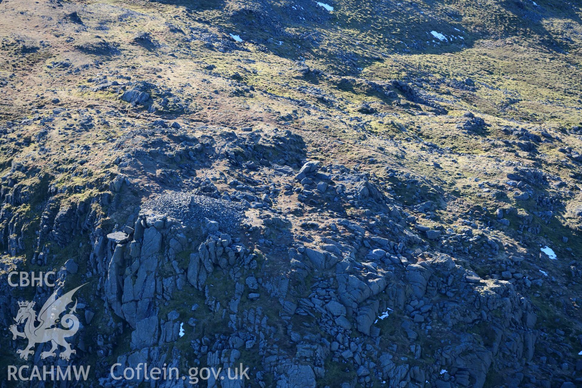 Oblique aerial photograph of Aran Fawddwy cairn and trig point taken during the Royal Commission’s programme of archaeological aerial reconnaissance by Toby Driver on 17th January 2022