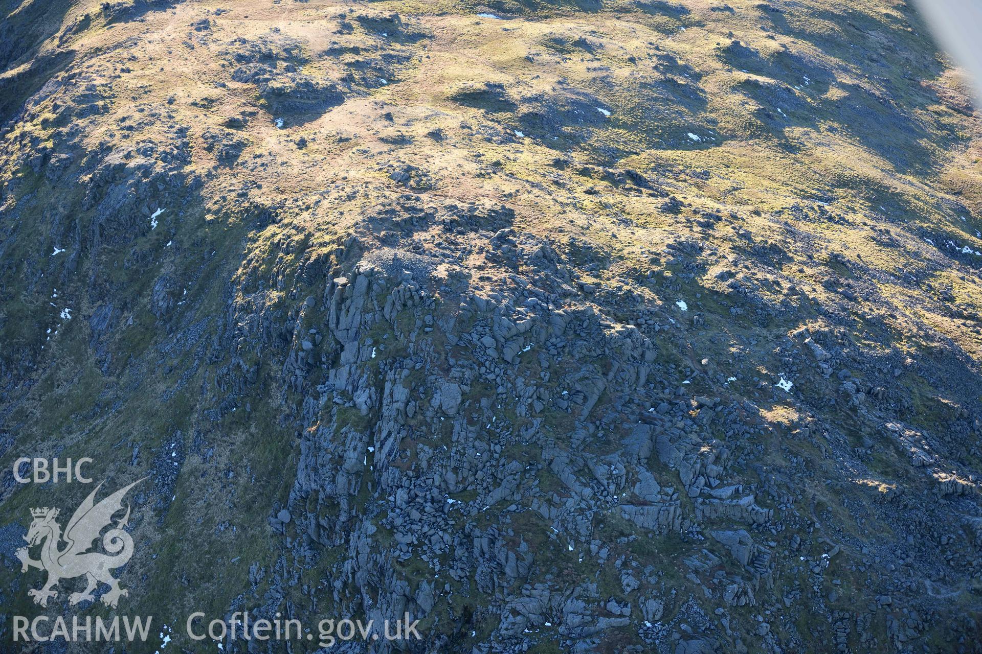 Oblique aerial photograph of Aran Fawddwy cairn and trig point taken during the Royal Commission’s programme of archaeological aerial reconnaissance by Toby Driver on 17th January 2022