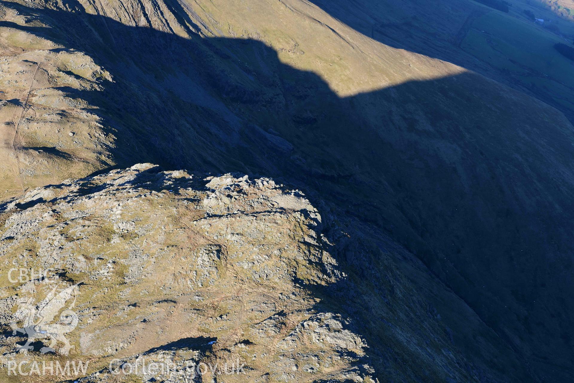 Oblique aerial photograph of Aran Fawddwy cairn and trig point taken during the Royal Commission’s programme of archaeological aerial reconnaissance by Toby Driver on 17th January 2022